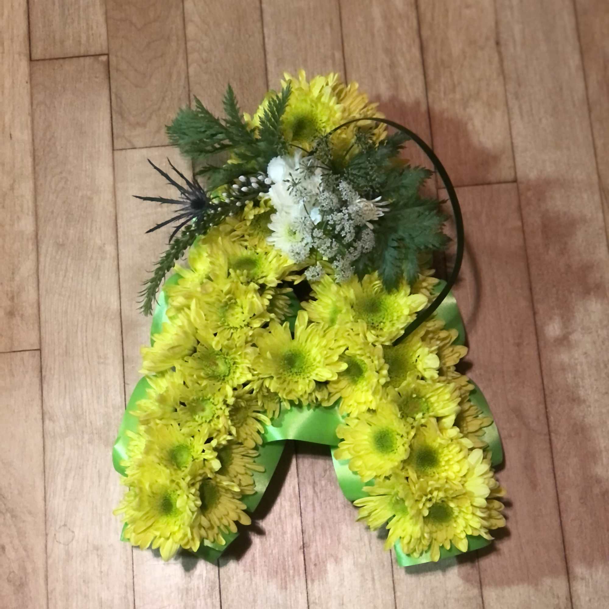 11 1/2" tall letter covered in chrysanthemums with a floral focal point