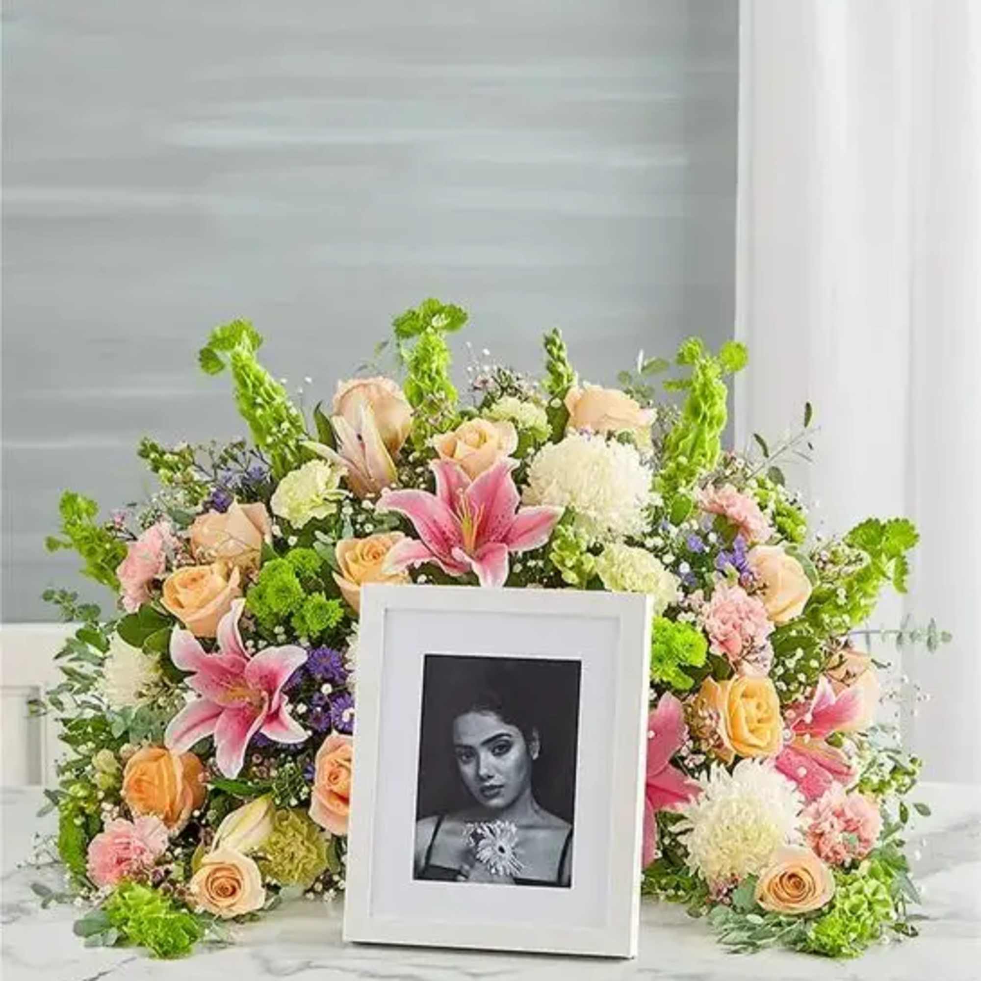 Express your heartfelt condolences with a beautiful floral tribute. Our crescent shaped
