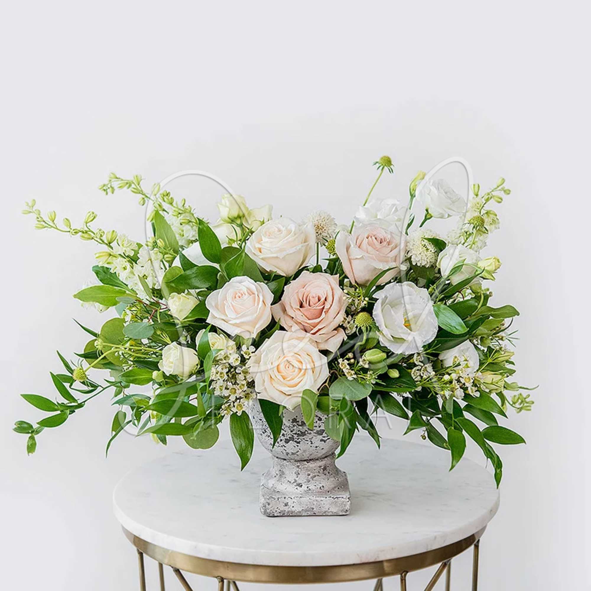 Neutral elegant arrangement that features white, nude and green florals in our