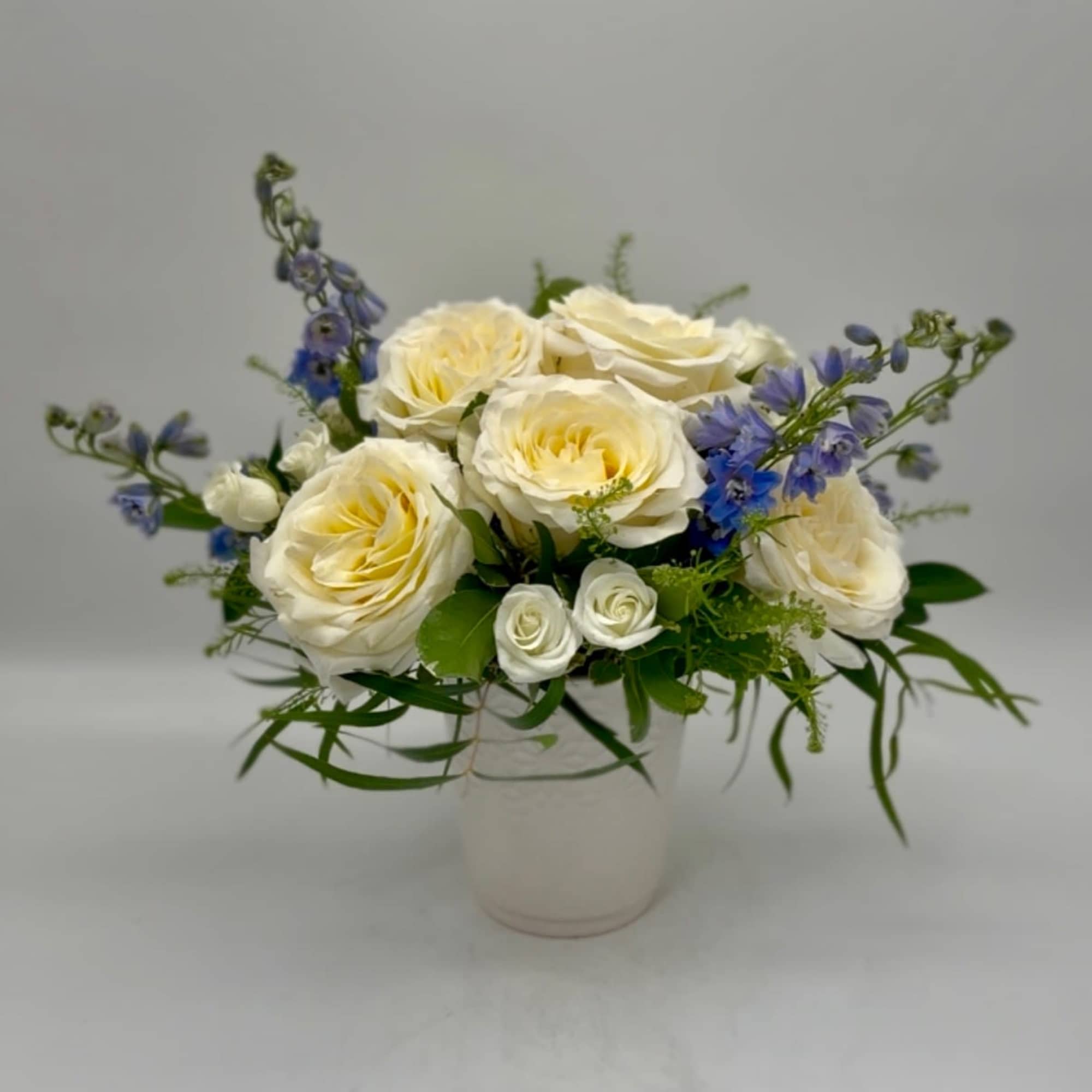 This modern display highlights 'Candlelight' garden roses (our owner's favorite variety), accented