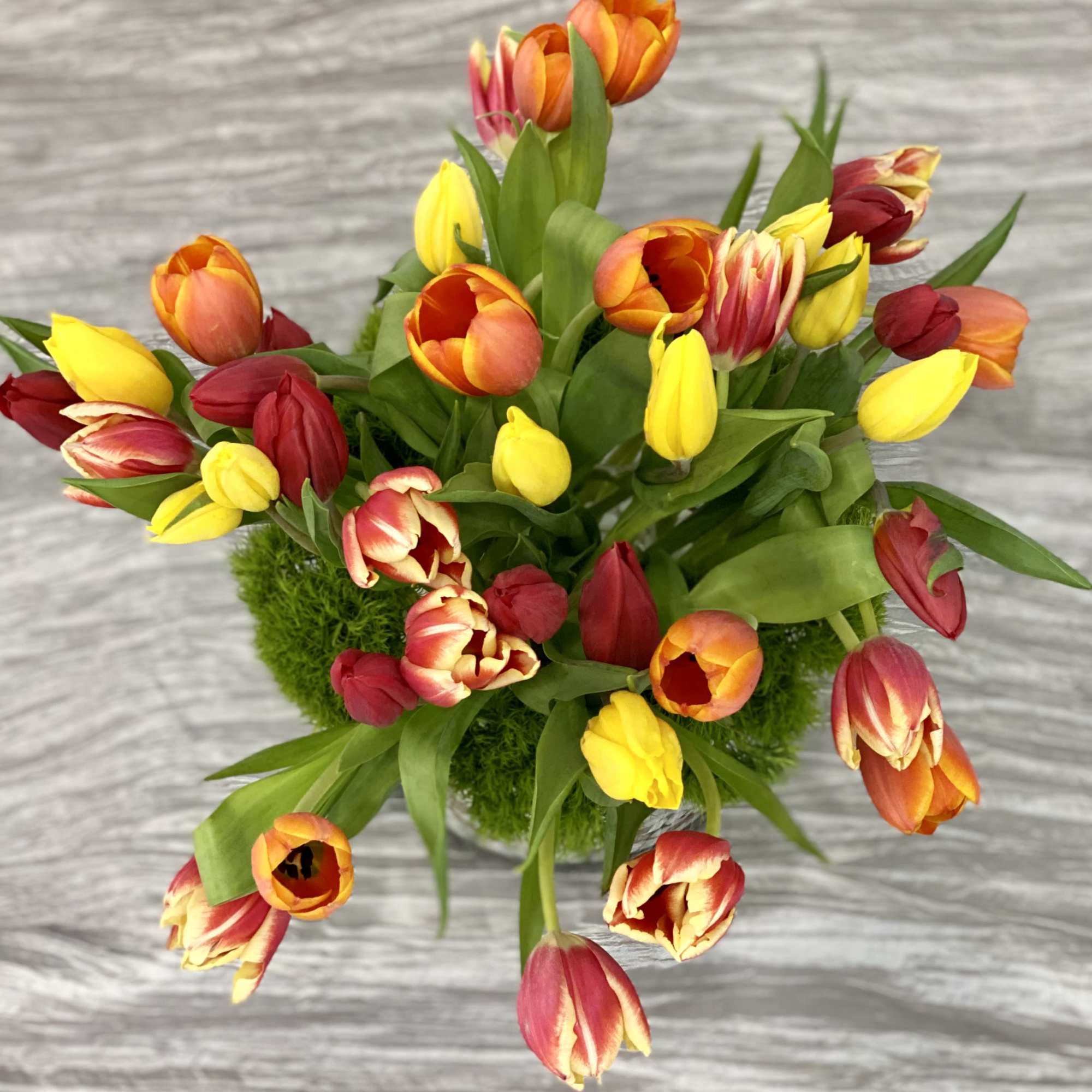 Welcome the flourishing season of spring with a bountiful yet modern arrangement