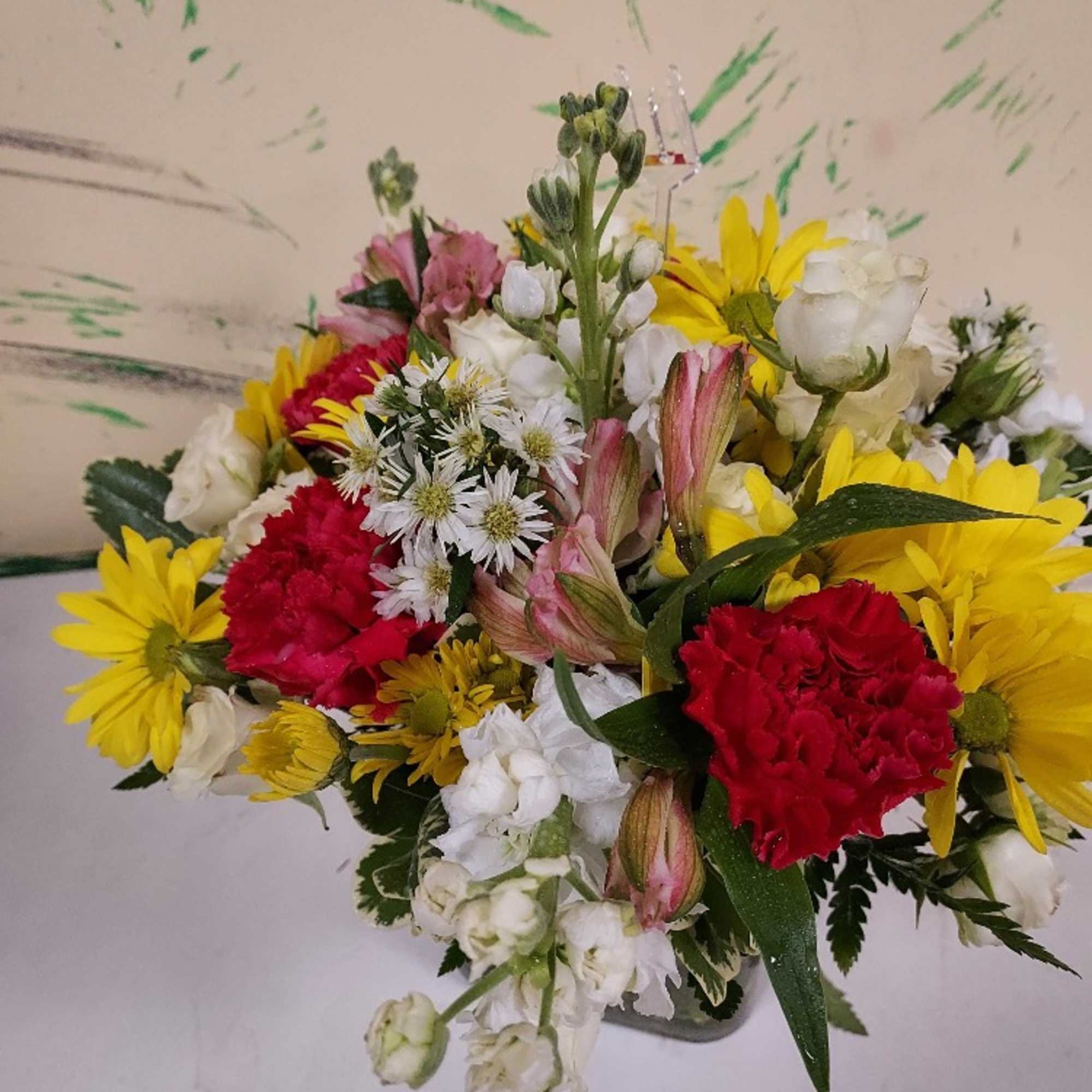 Bright colorful blooms in a sleek glass cube. This arrangement is perfect