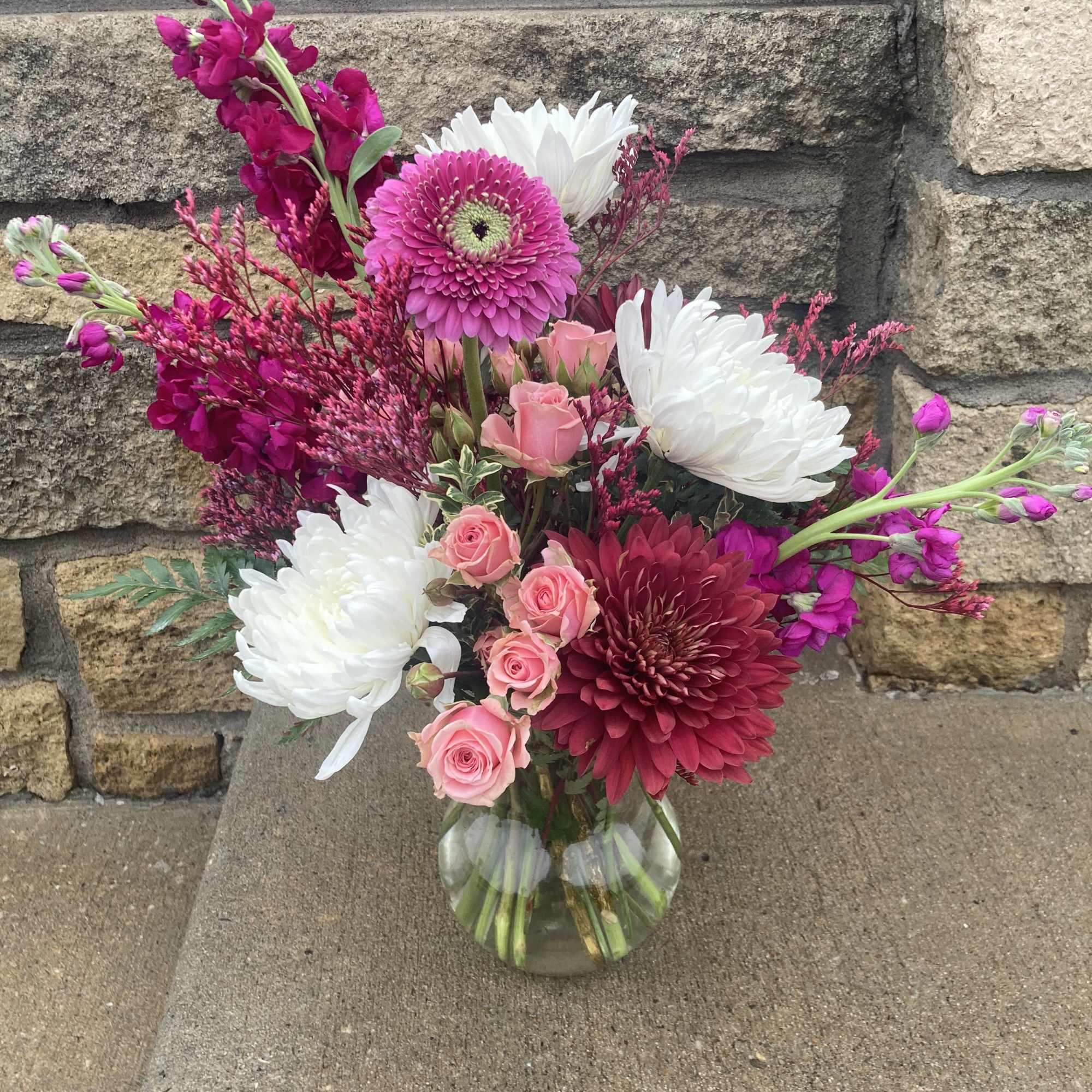 This sweet arrangement is sure to brighten anyone&rsquo;s day. Featuring pink, magenta