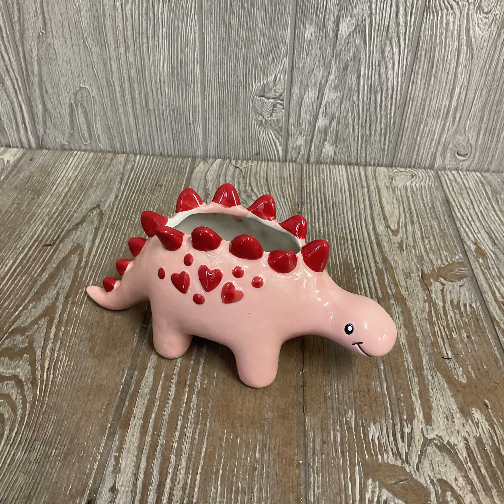 This sweet arrangement in a ceramic keepsake stegosaurus container is perfect to