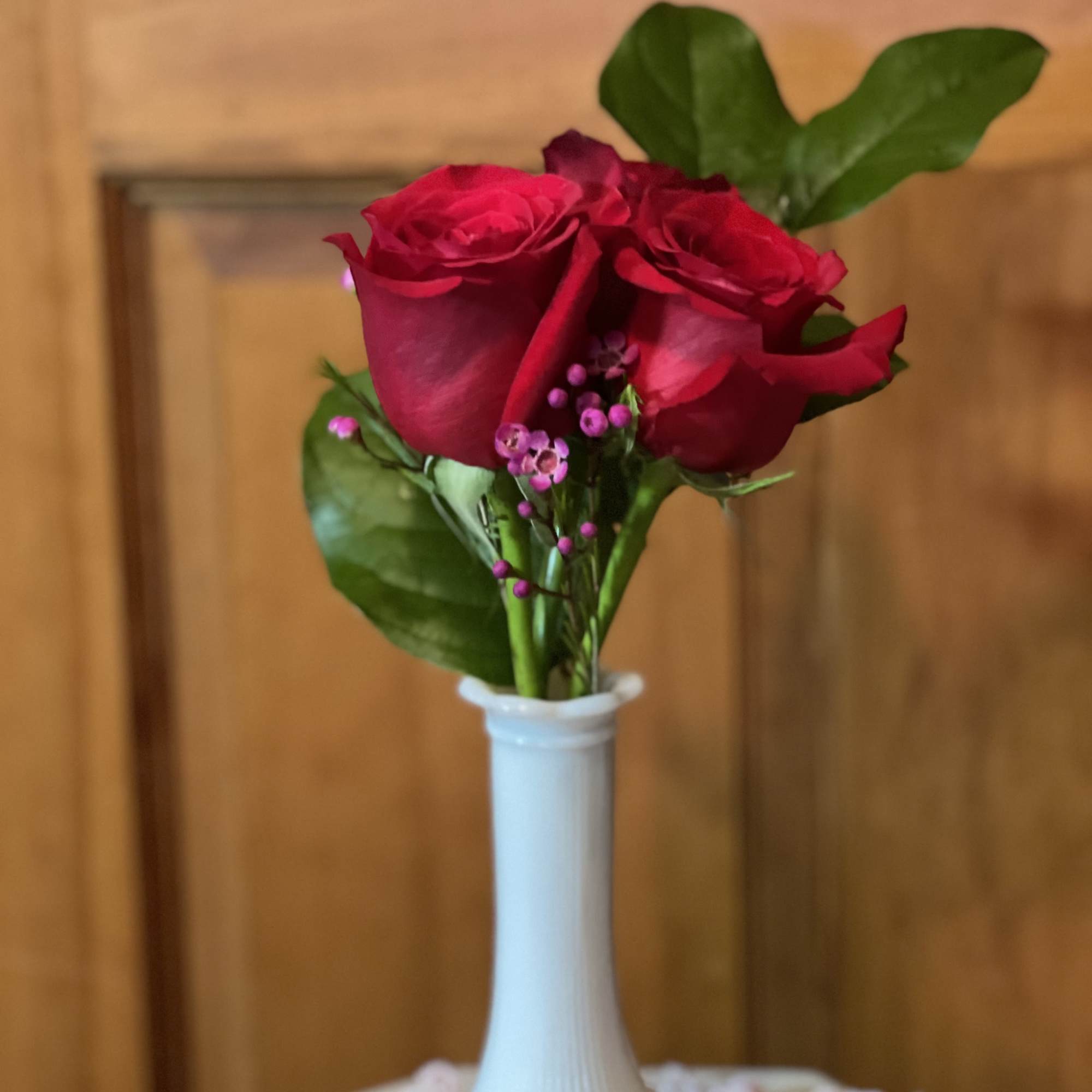 Young Love blooms with 3 petite roses (color will be florist's choice)