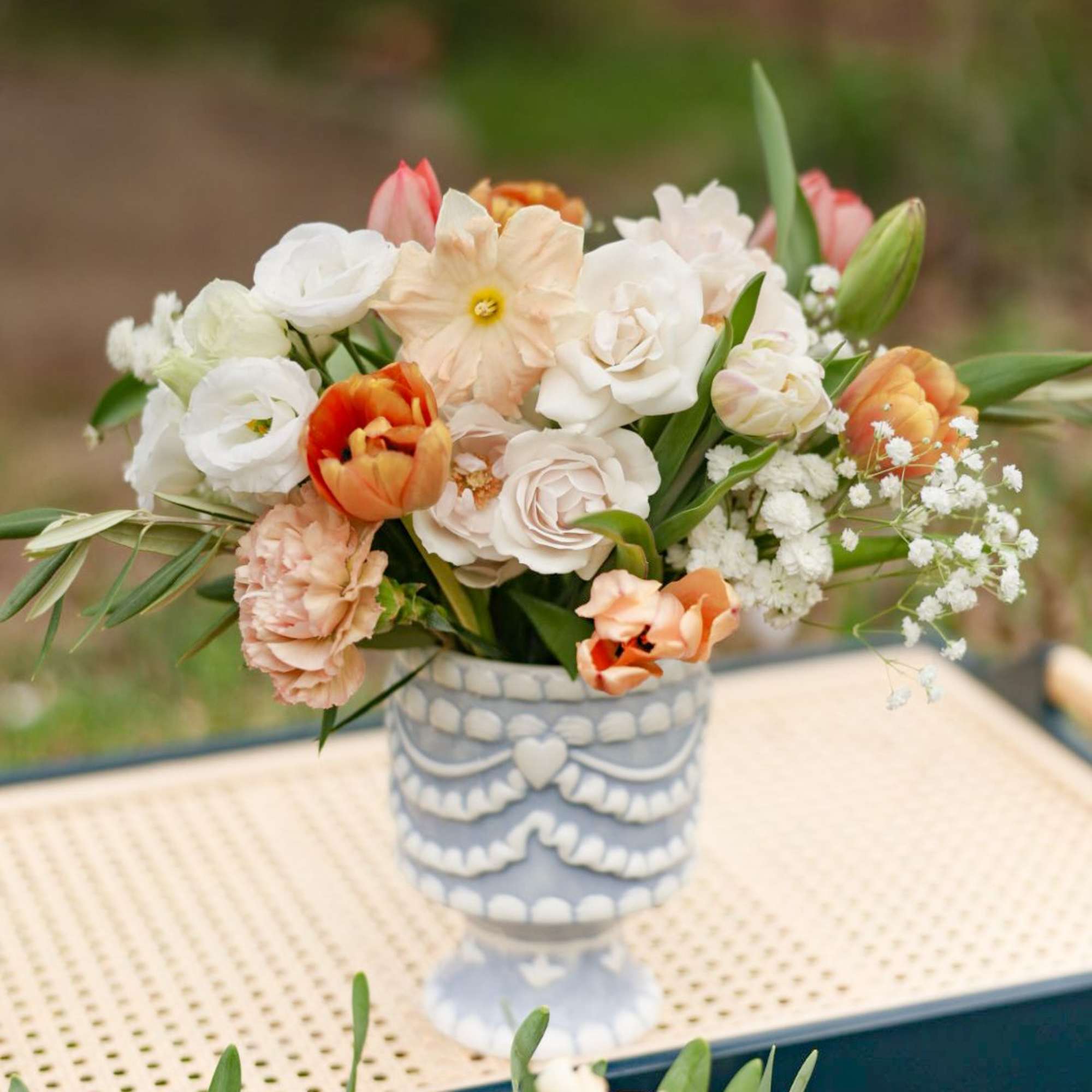 A fun arrangement in a ceramic "cake" vase. 