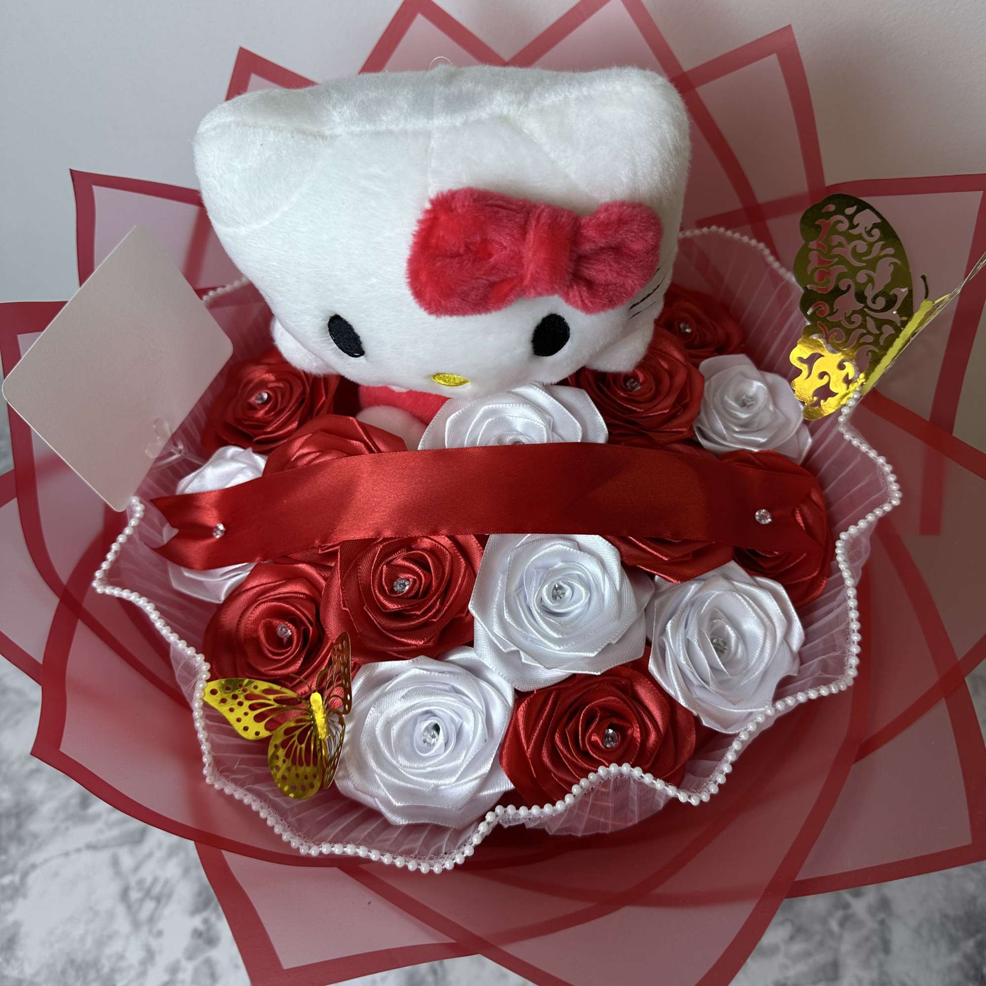 Hello Kitty eternal bouquets with roses and a Hello Kitty plushie.