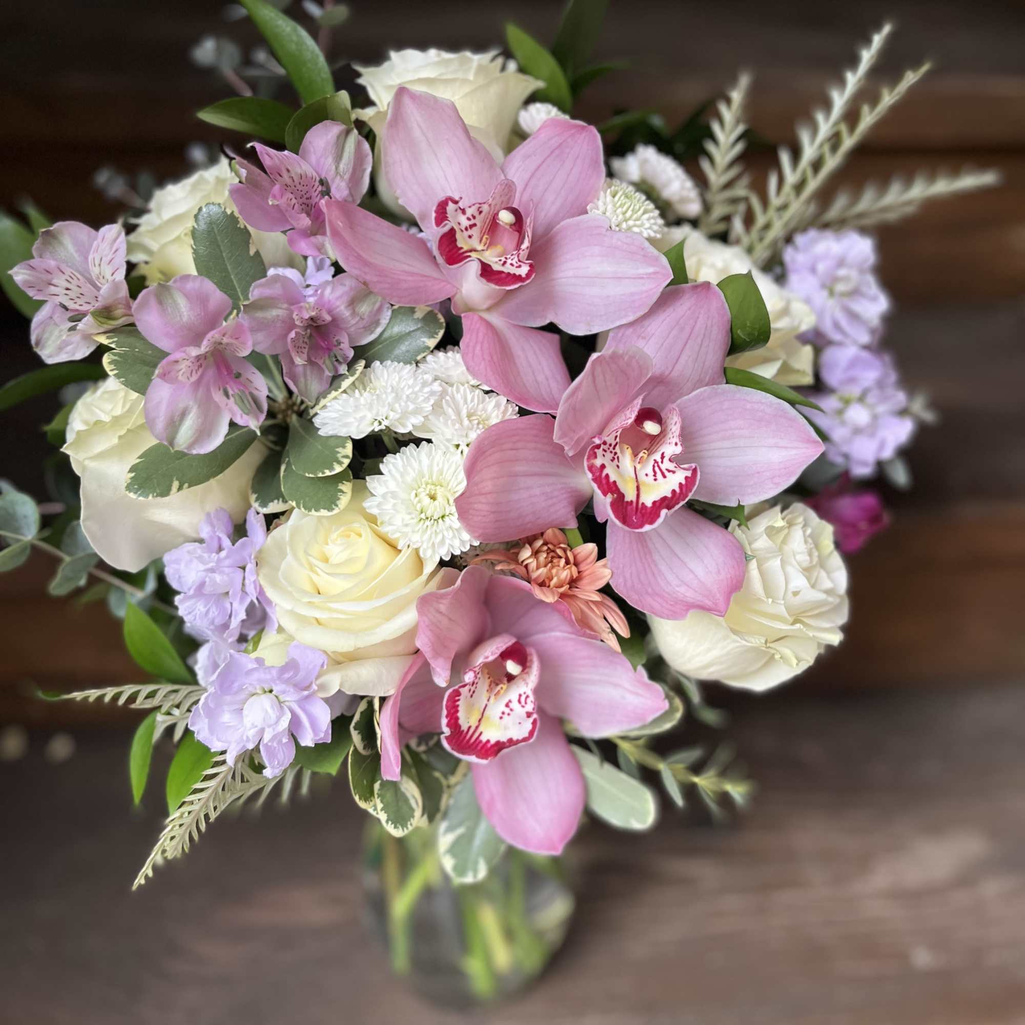 White Rose front facing bouquet with lavender orchids and accent florals and