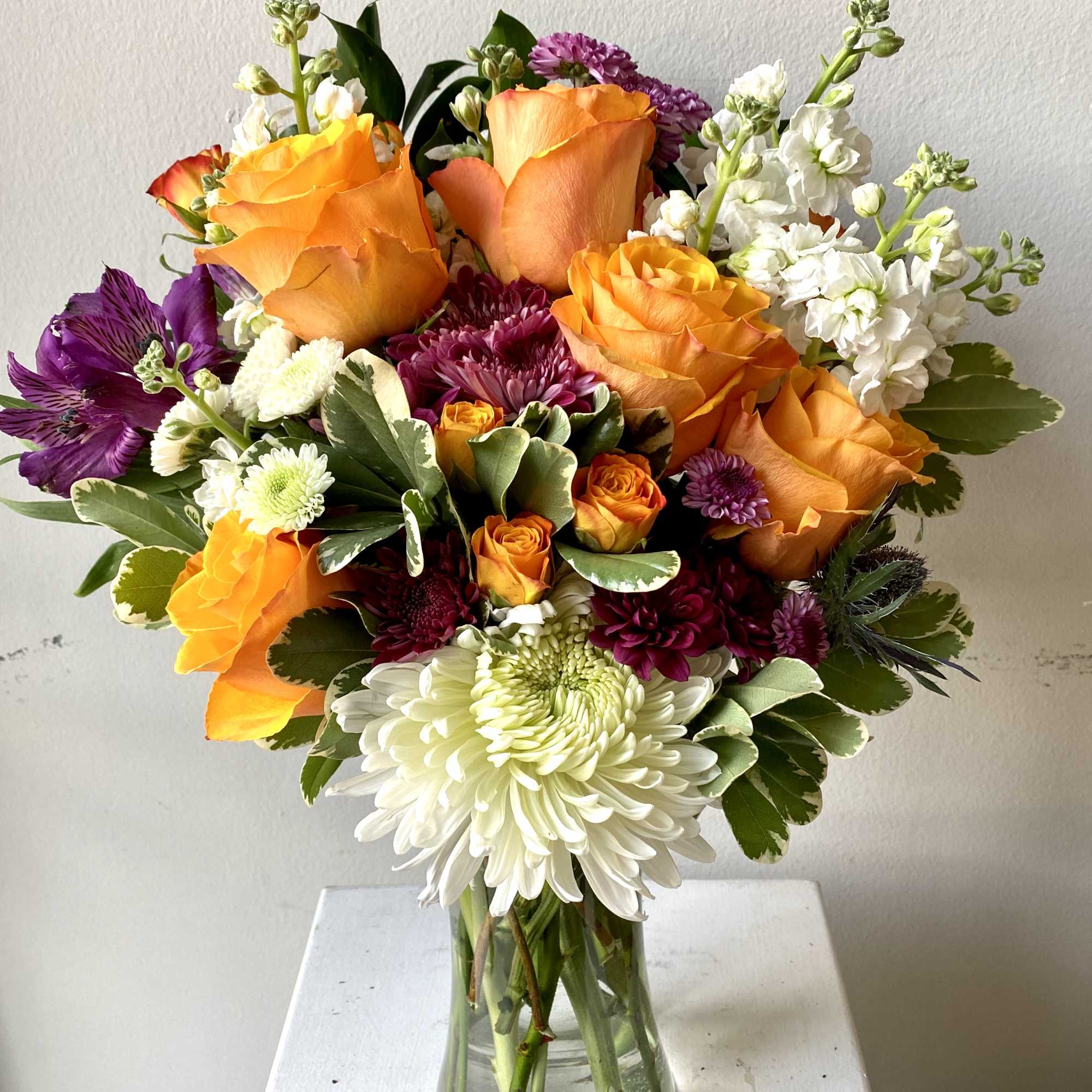 Perfect blend of roses and complimentary florals and greenery artistically put together