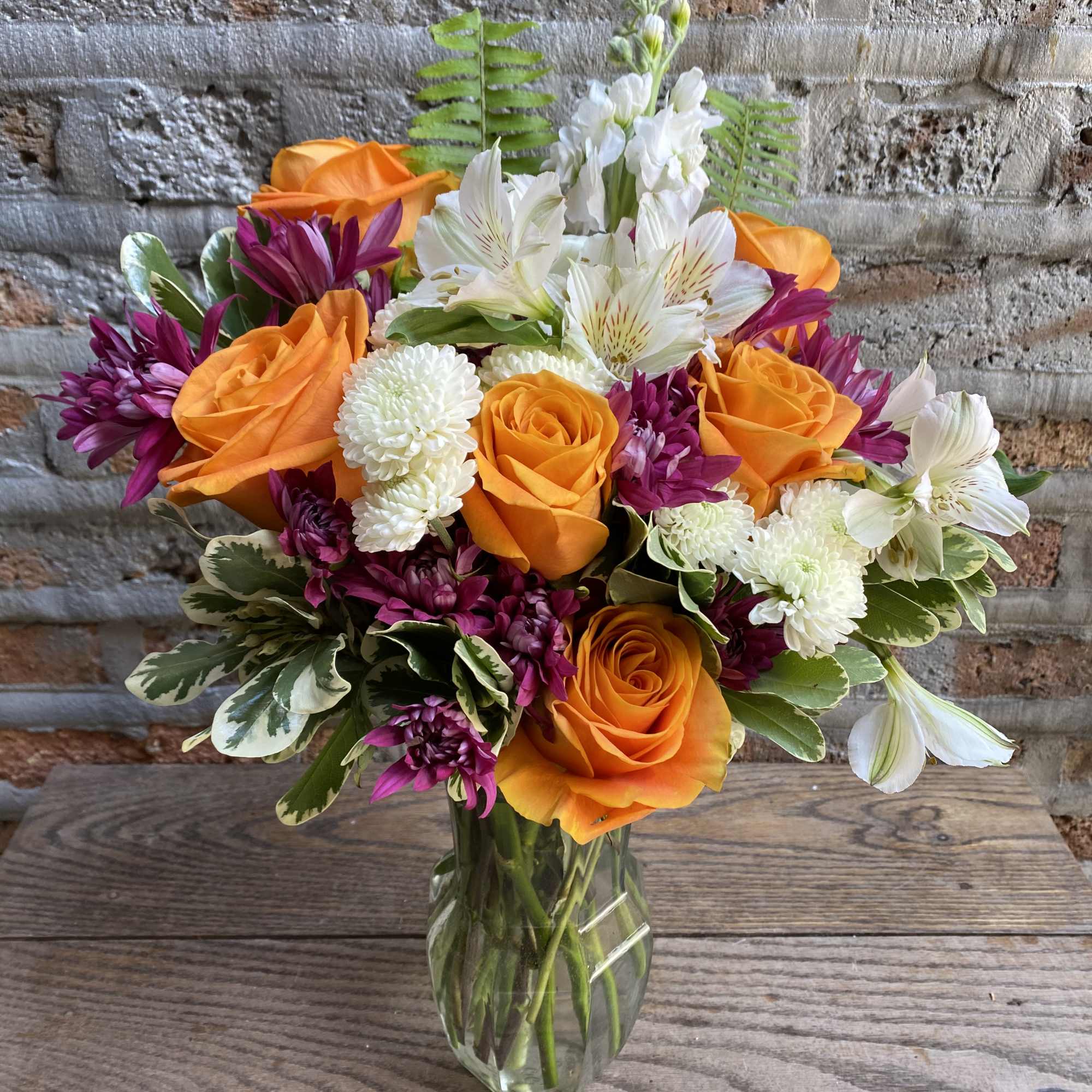 Perfect blend of roses and complimentary florals and greenery artistically put together