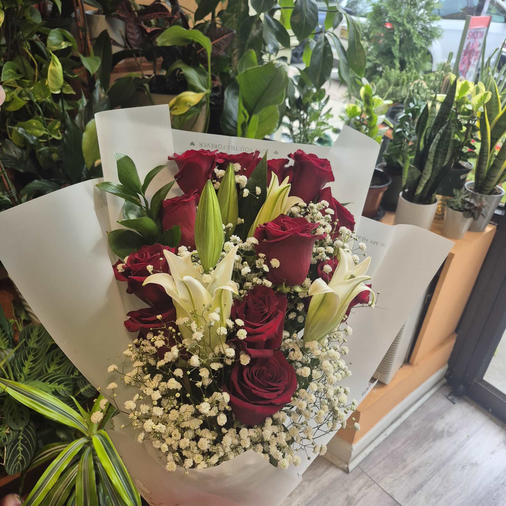 Bouquet of roses with lilies and decorations according to store availability