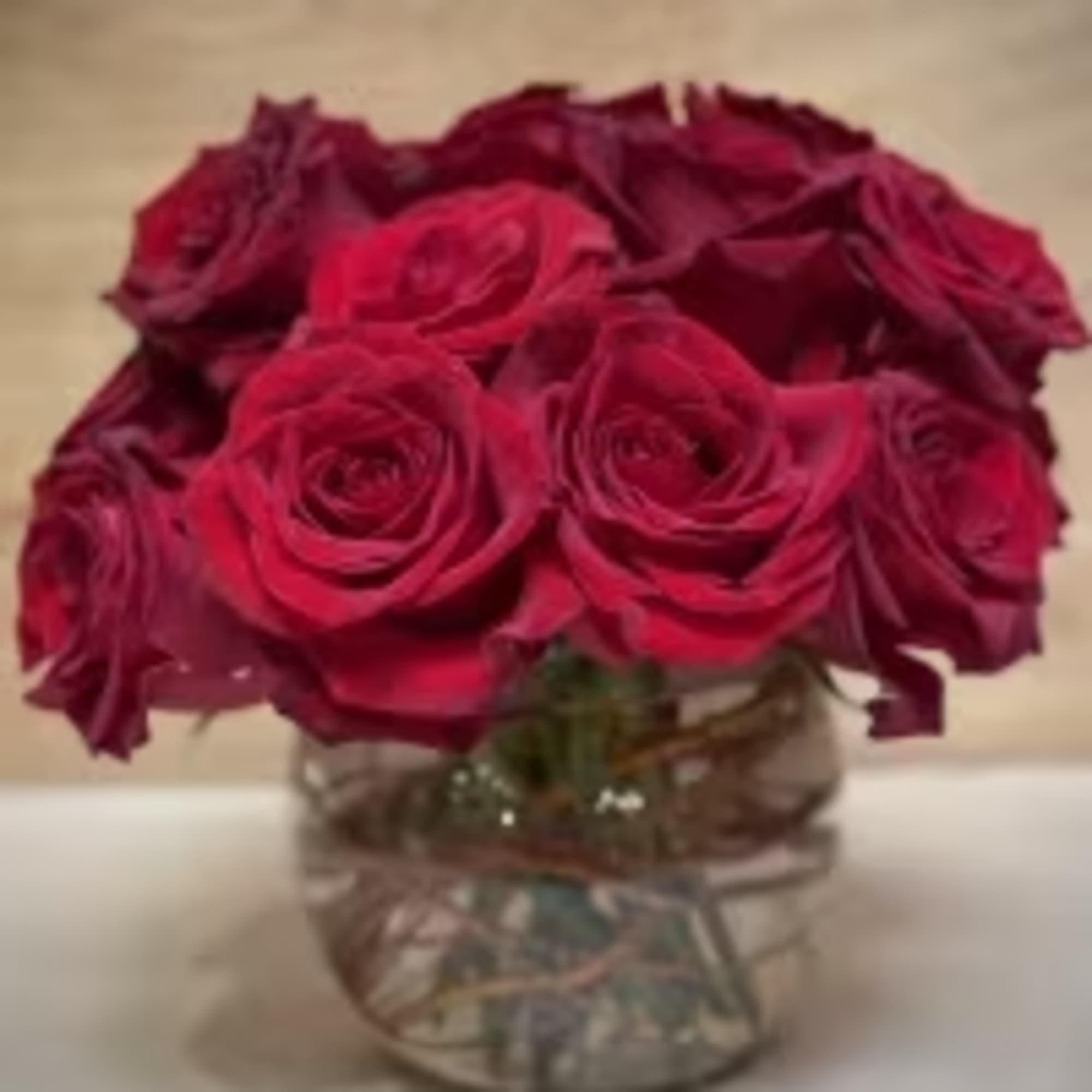 15 red roses exquisitely arranged in a 6" bubble bowl..
Height: Approximately 10"