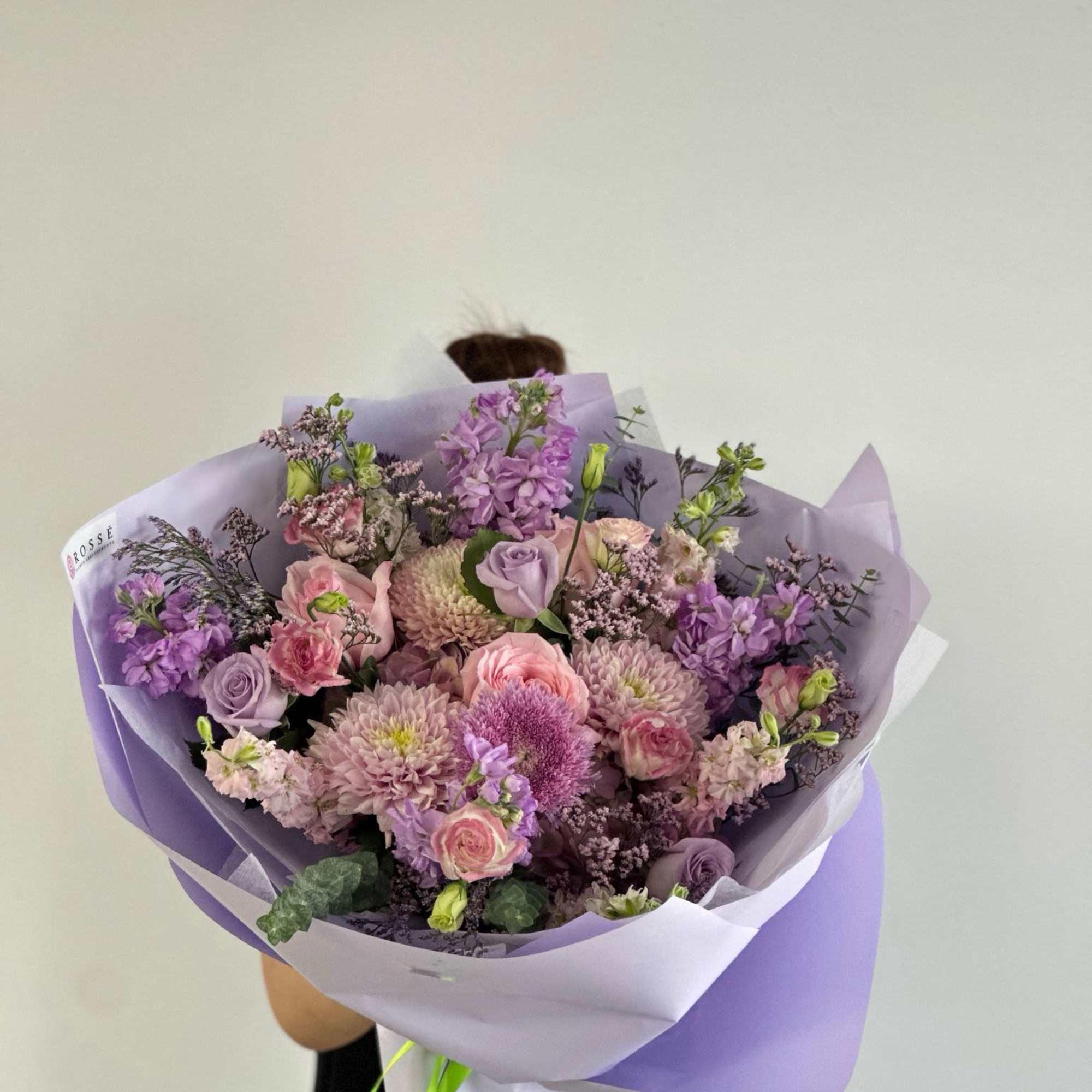 A bouquet pastel mix of lavender and pink flowers arranged in a
