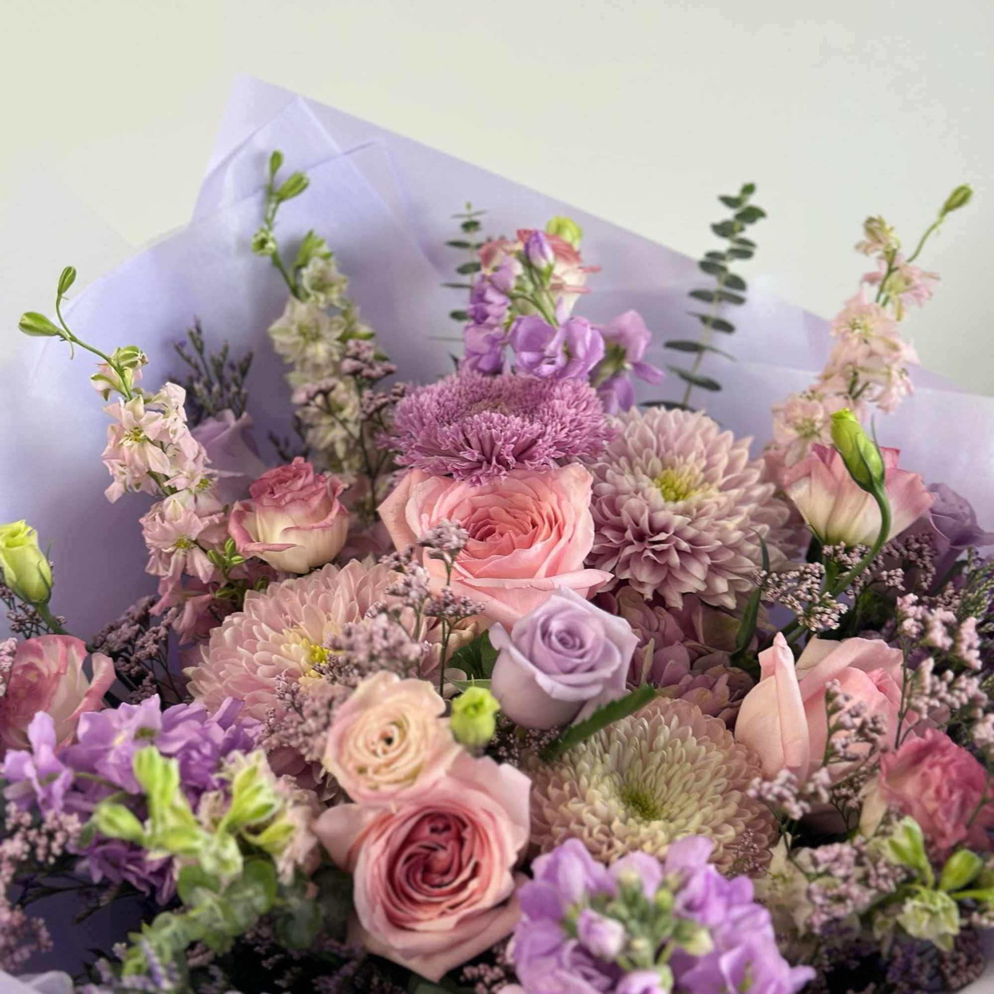 A bouquet pastel mix of lavender and pink flowers arranged in a