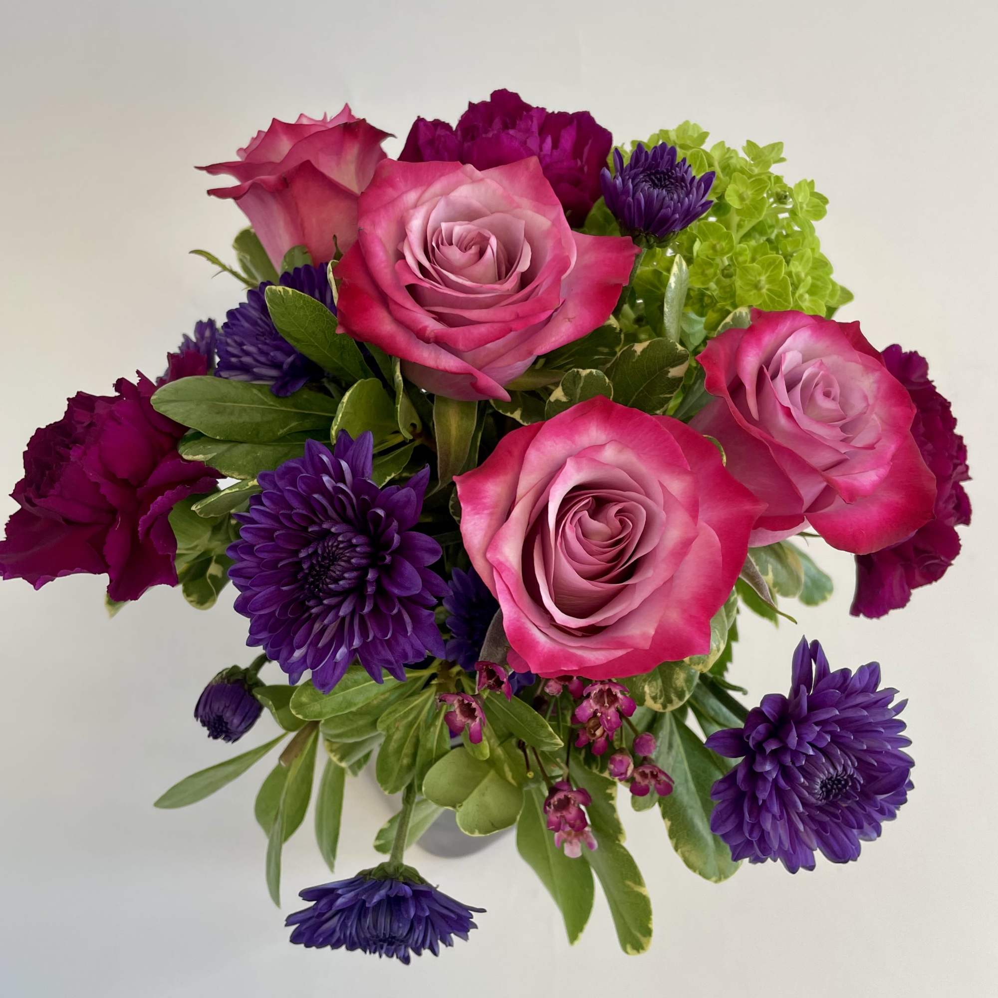 A combination of purples and greens designed in a cube. 