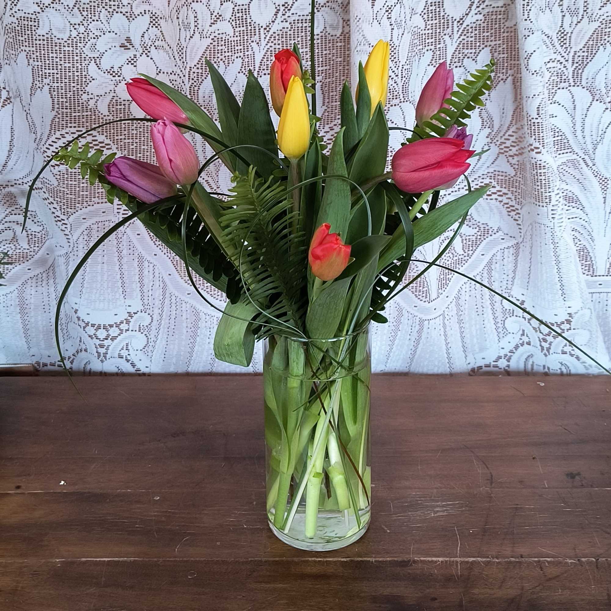 This bright mix color bouquet of tulips will bring sunshine and smiles.