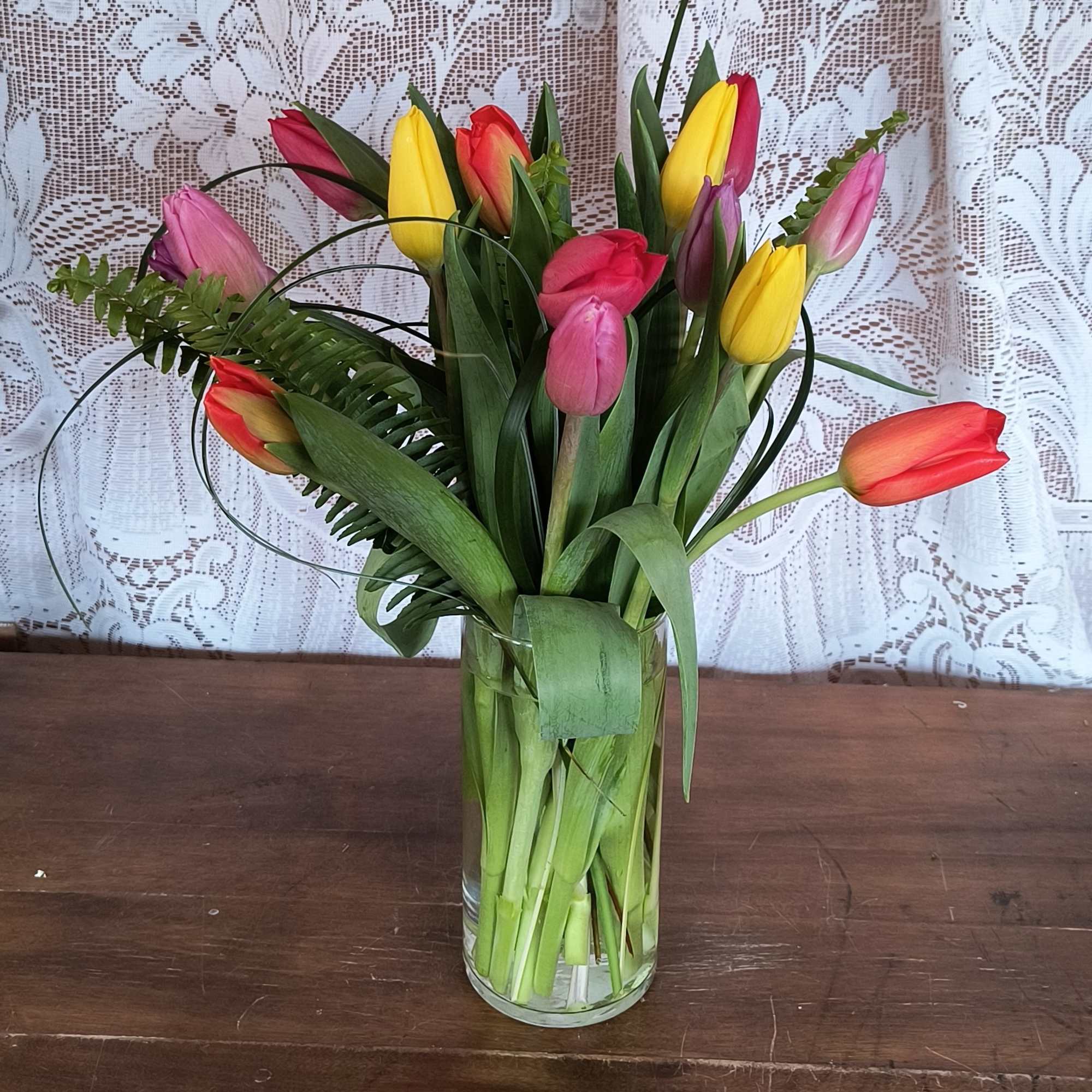 This bright mix color bouquet of tulips will bring sunshine and smiles.