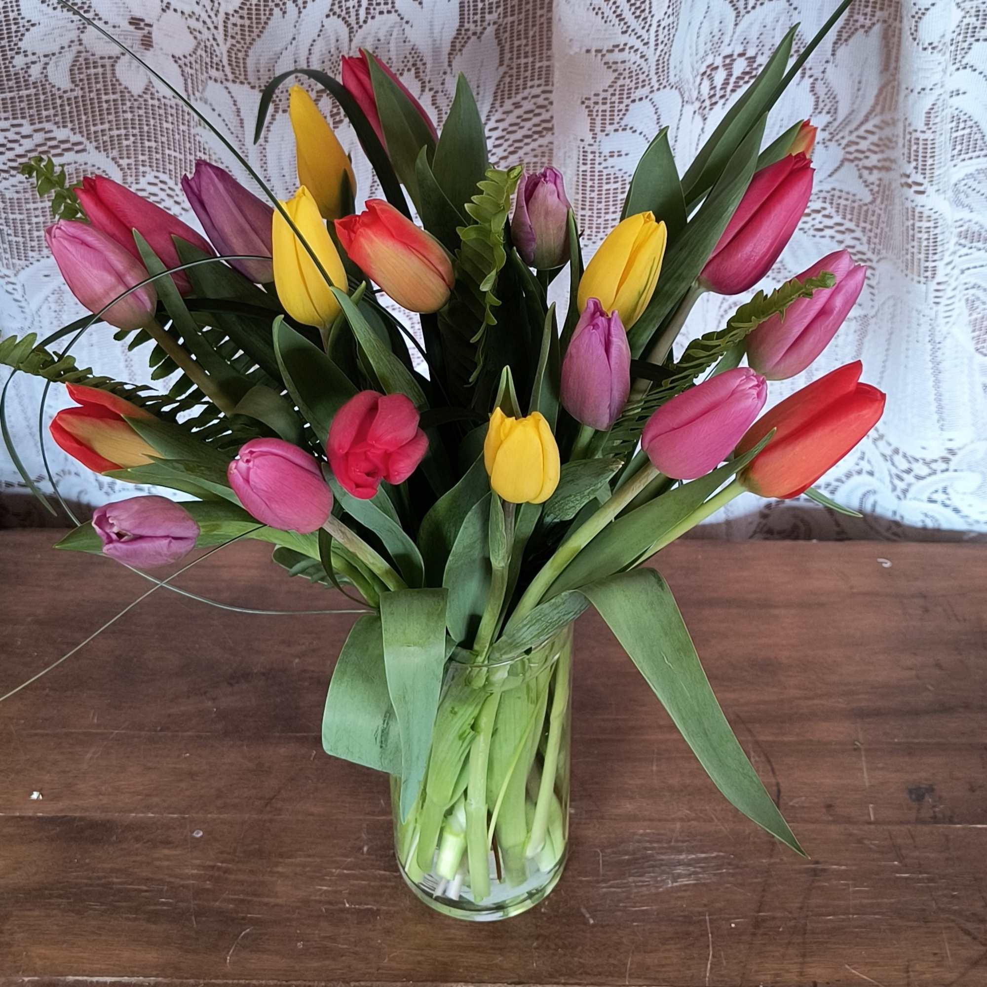 This bright mix color bouquet of tulips will bring sunshine and smiles.
