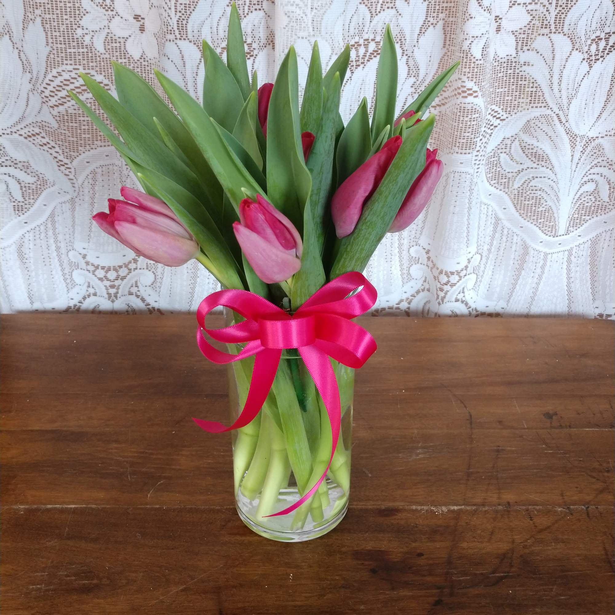 Pink Tulips arranged in a glass vase.