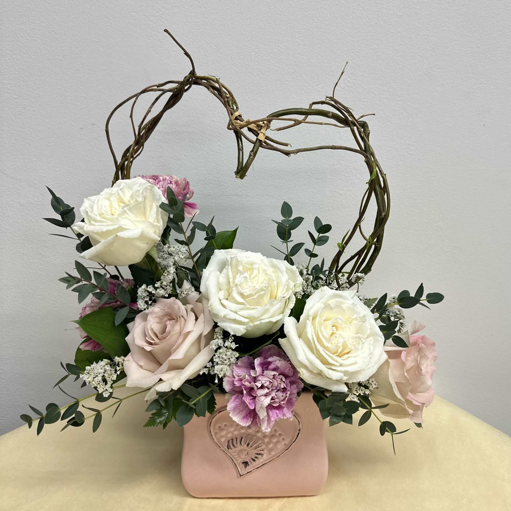Evoking the playful spirit of Cupid, this enchanting arrangement captures the essence