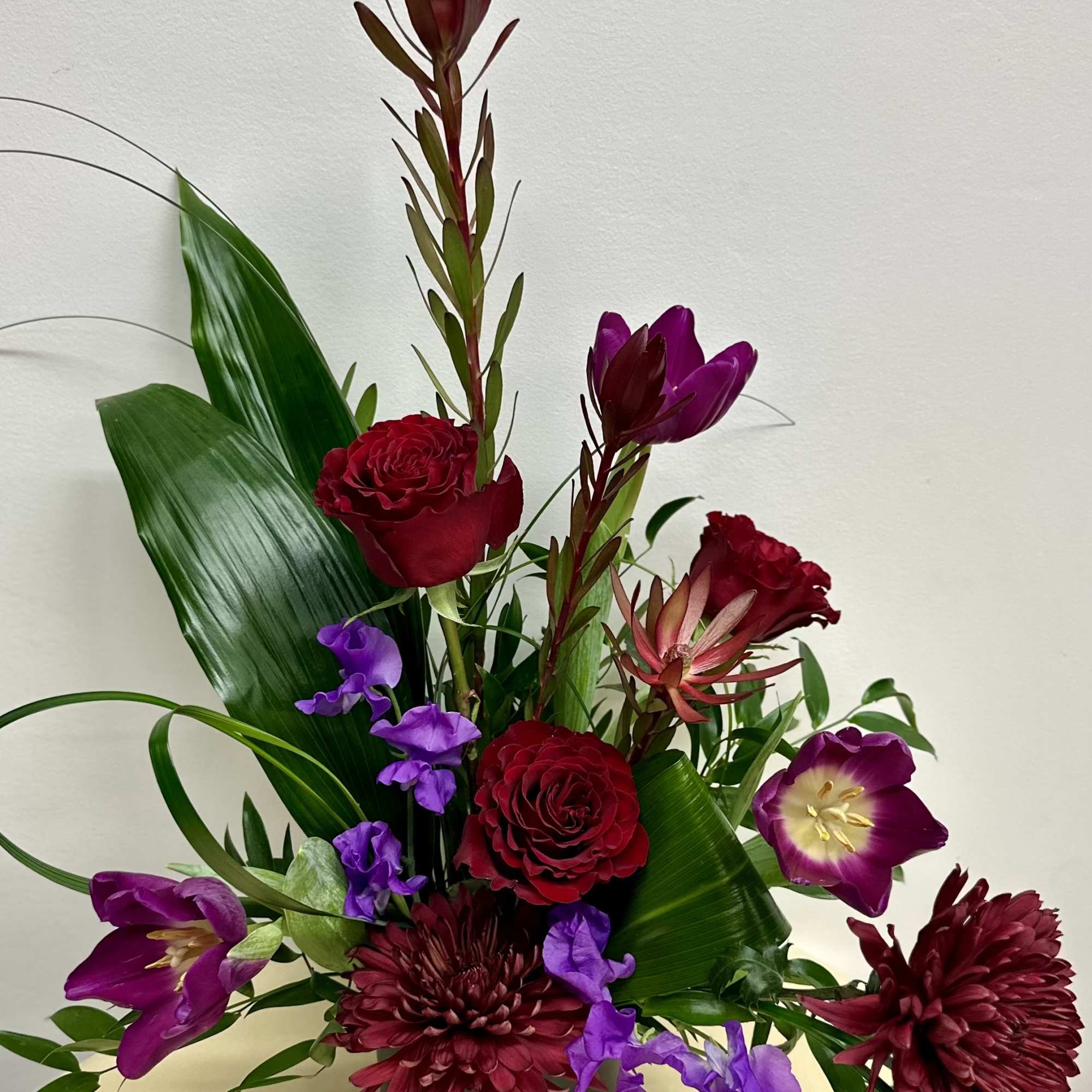  A captivating arrangement that embraces deep, moody elegance with a bit