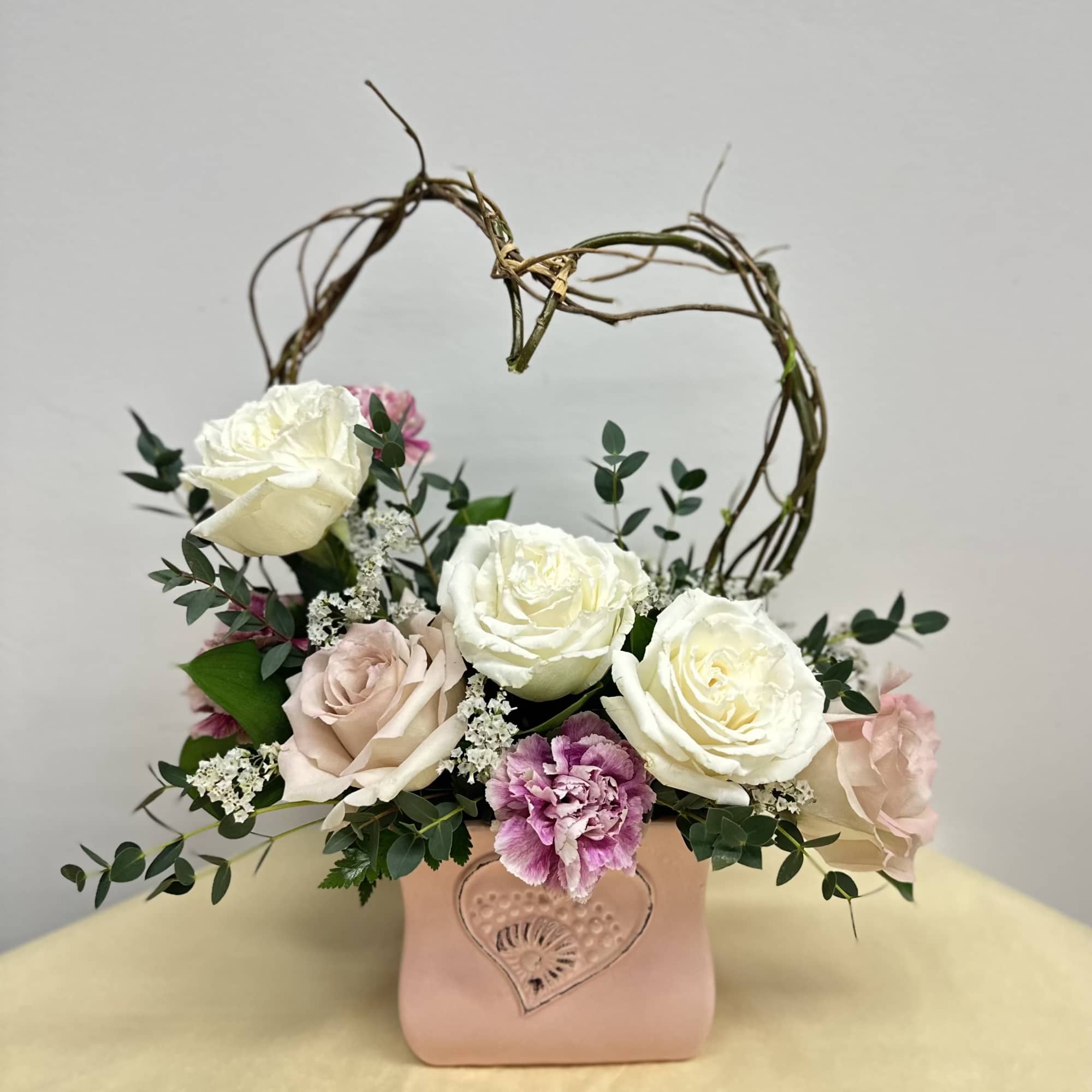 Evoking the playful spirit of Cupid, this enchanting arrangement captures the essence