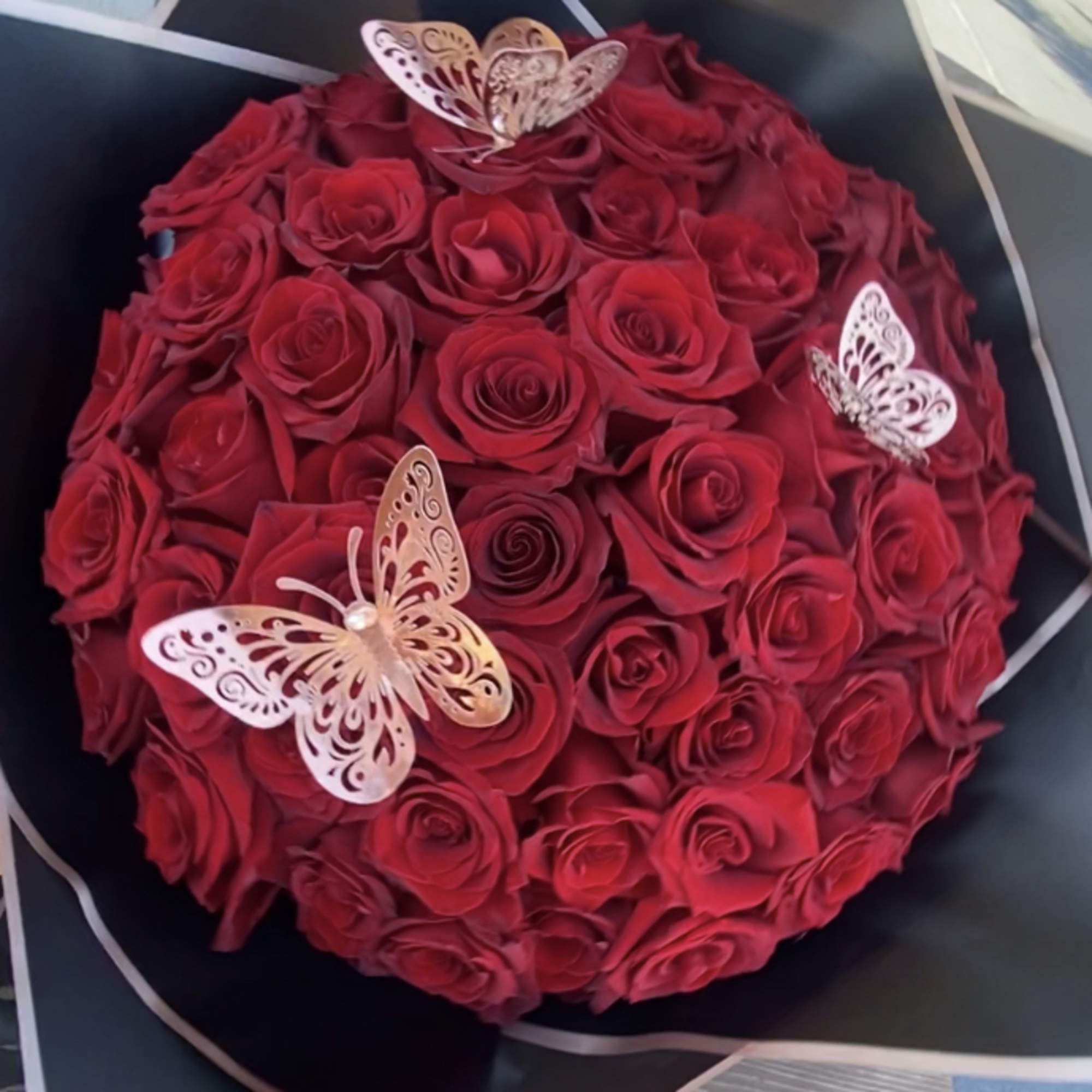 50  Ecuadorian Long stem Red Roses wrap in black Korean paper.