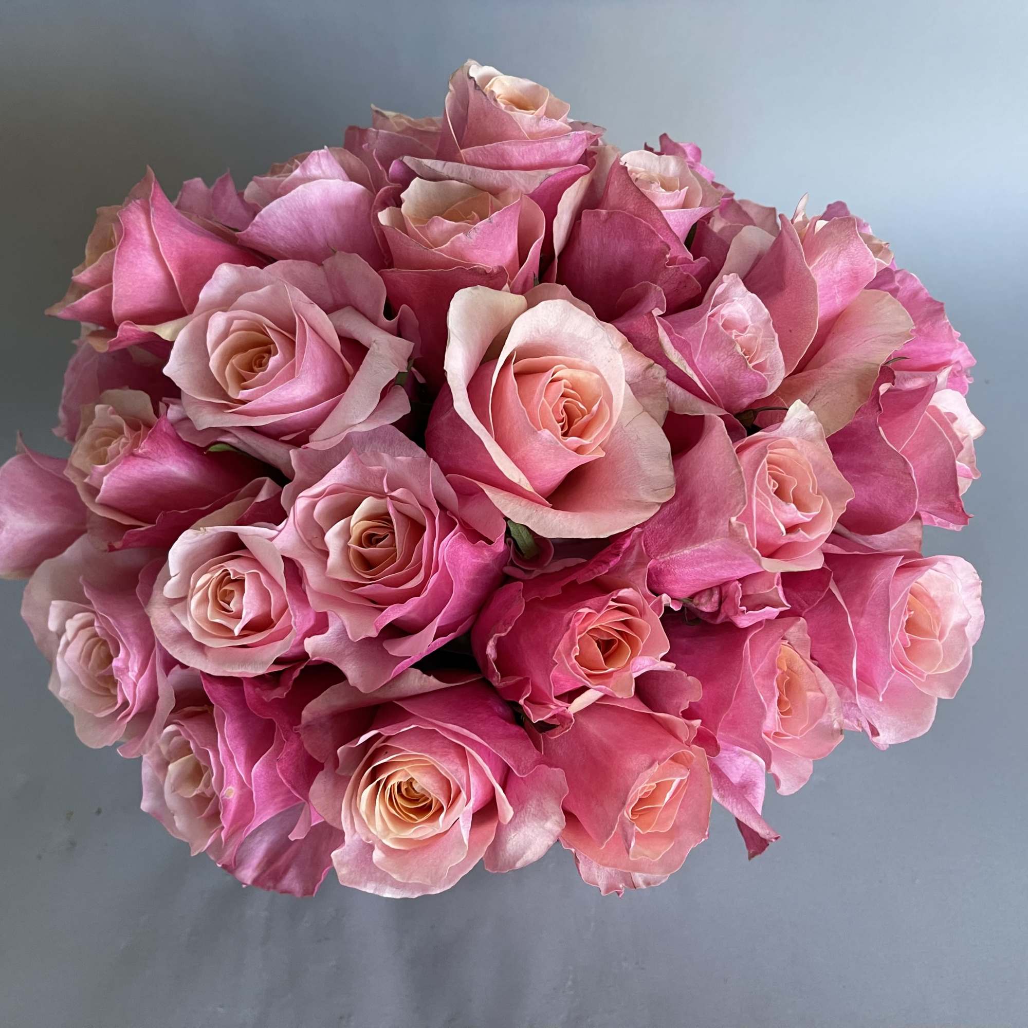 30 stems of flamingo pink roses and a rose gold or silver