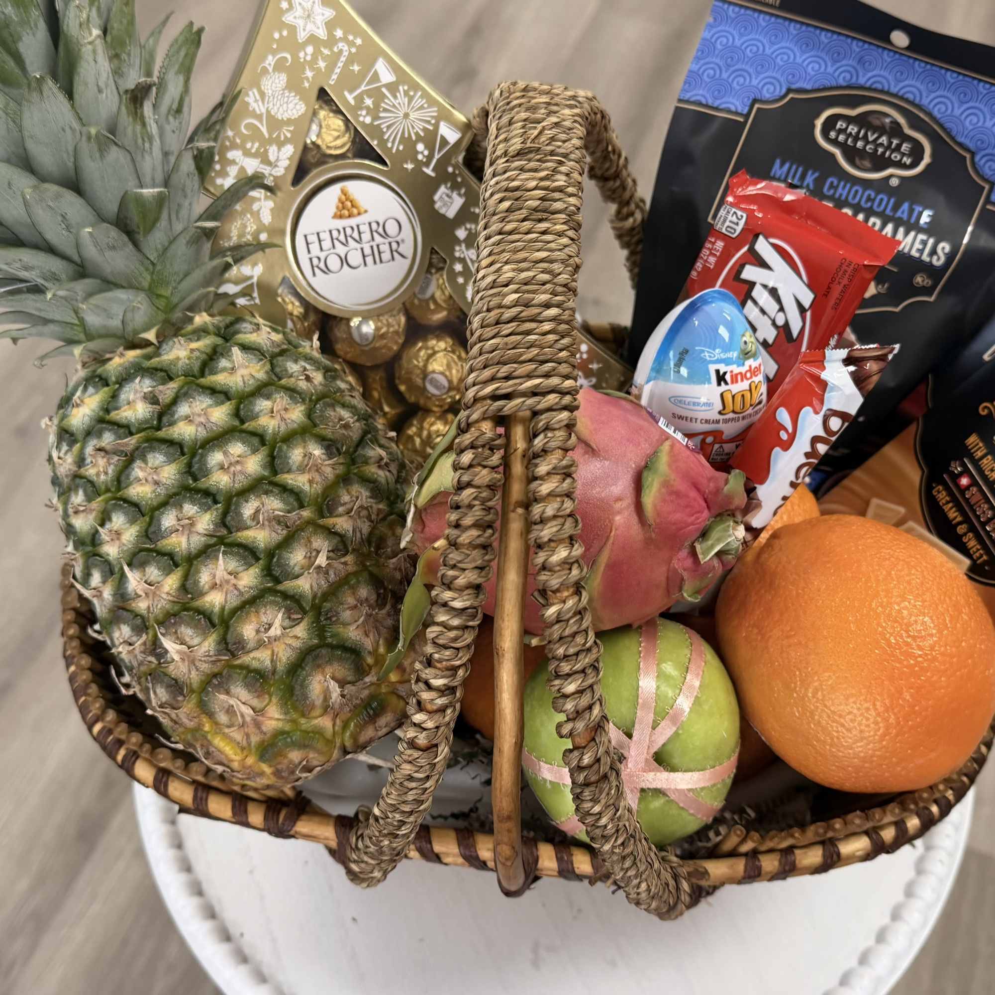 A beautifully arranged gourmet basket filled with fresh tropical fruits and premium