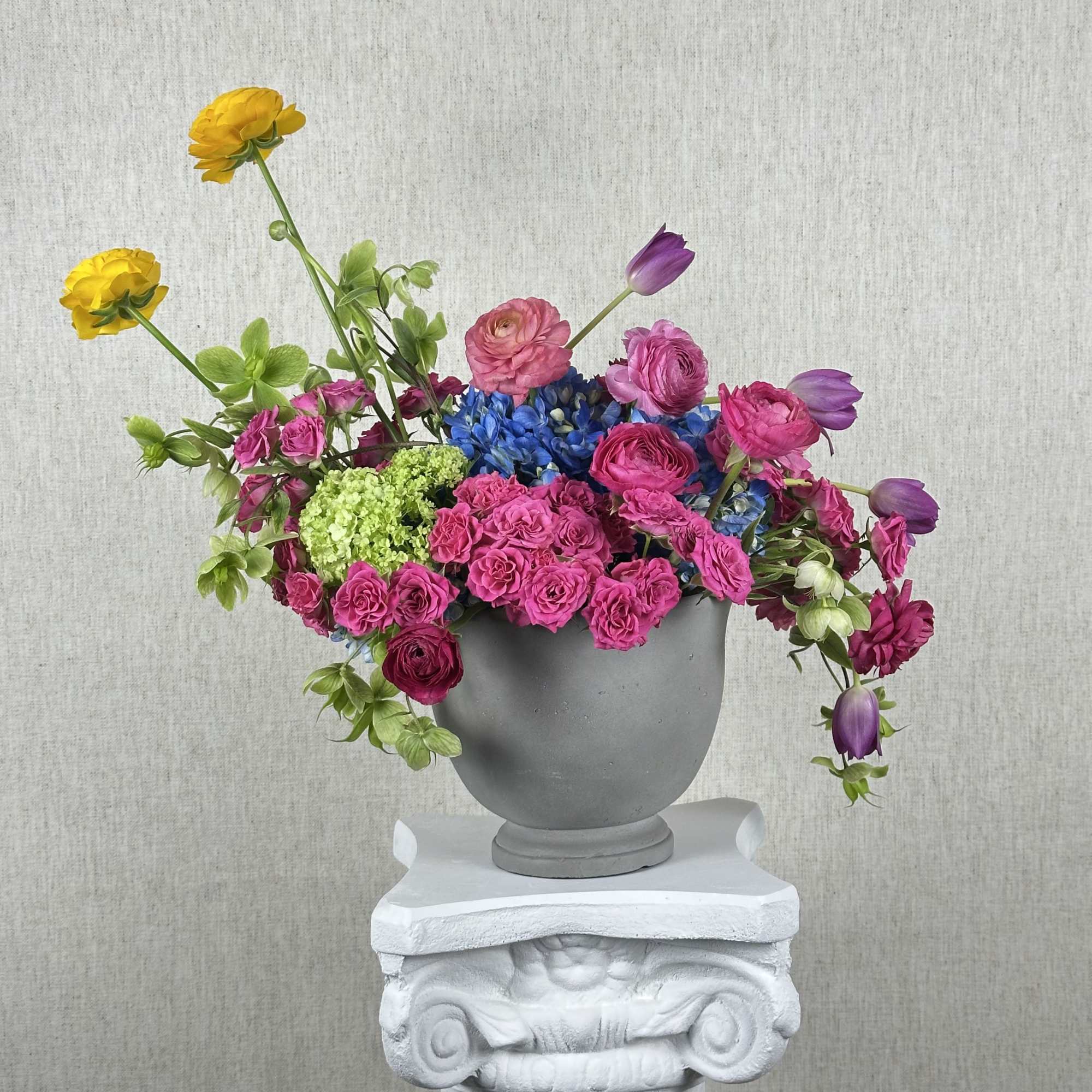 A just blend of fresh blooms. Vibrant roses, hydrangeas, tulips, ranunculus, and