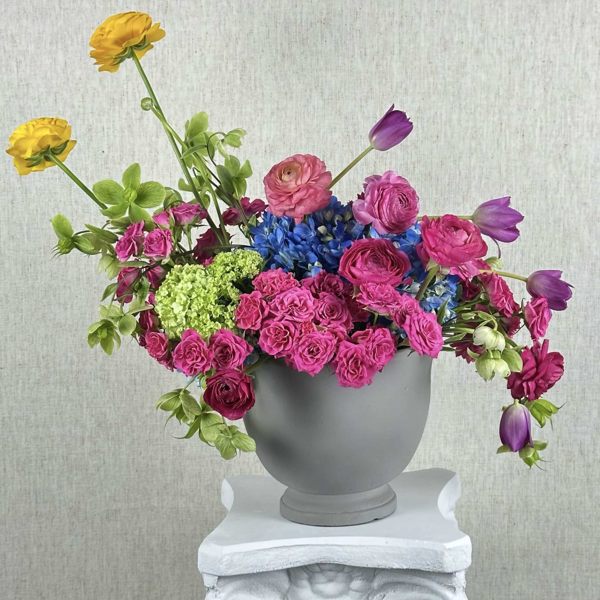 A just blend of fresh blooms. Vibrant roses, hydrangeas, tulips, ranunculus, and