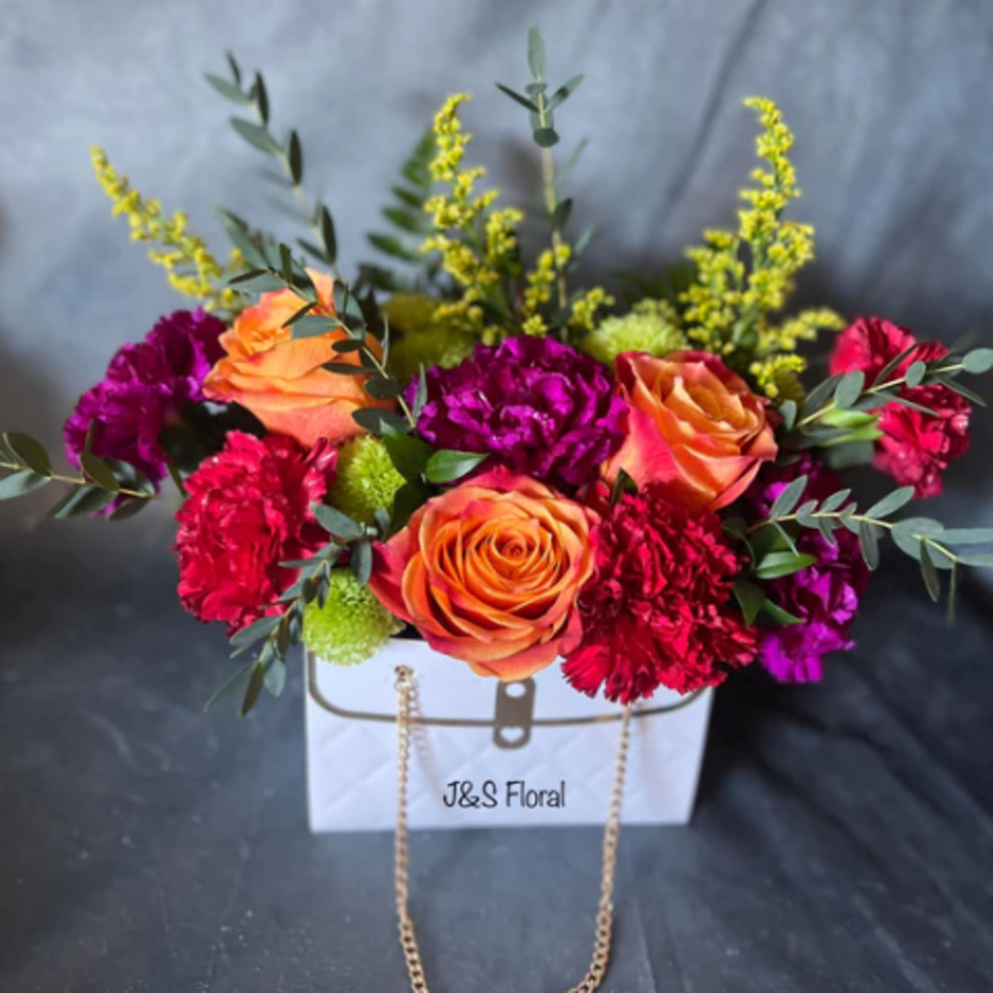 Step into a world of vibrant delight with our cheerful flower arrangement