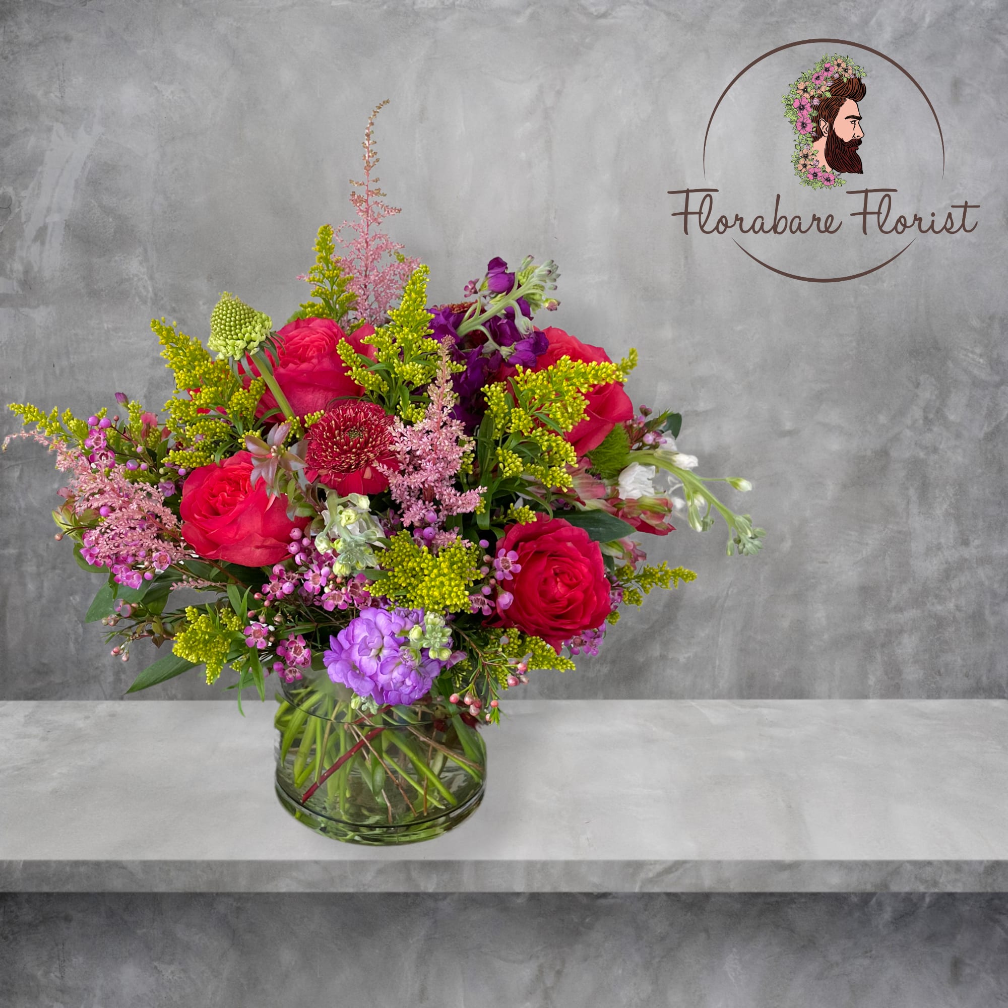 Lush floral design filled with vibrant colors. Consisting of seasonal flowers and