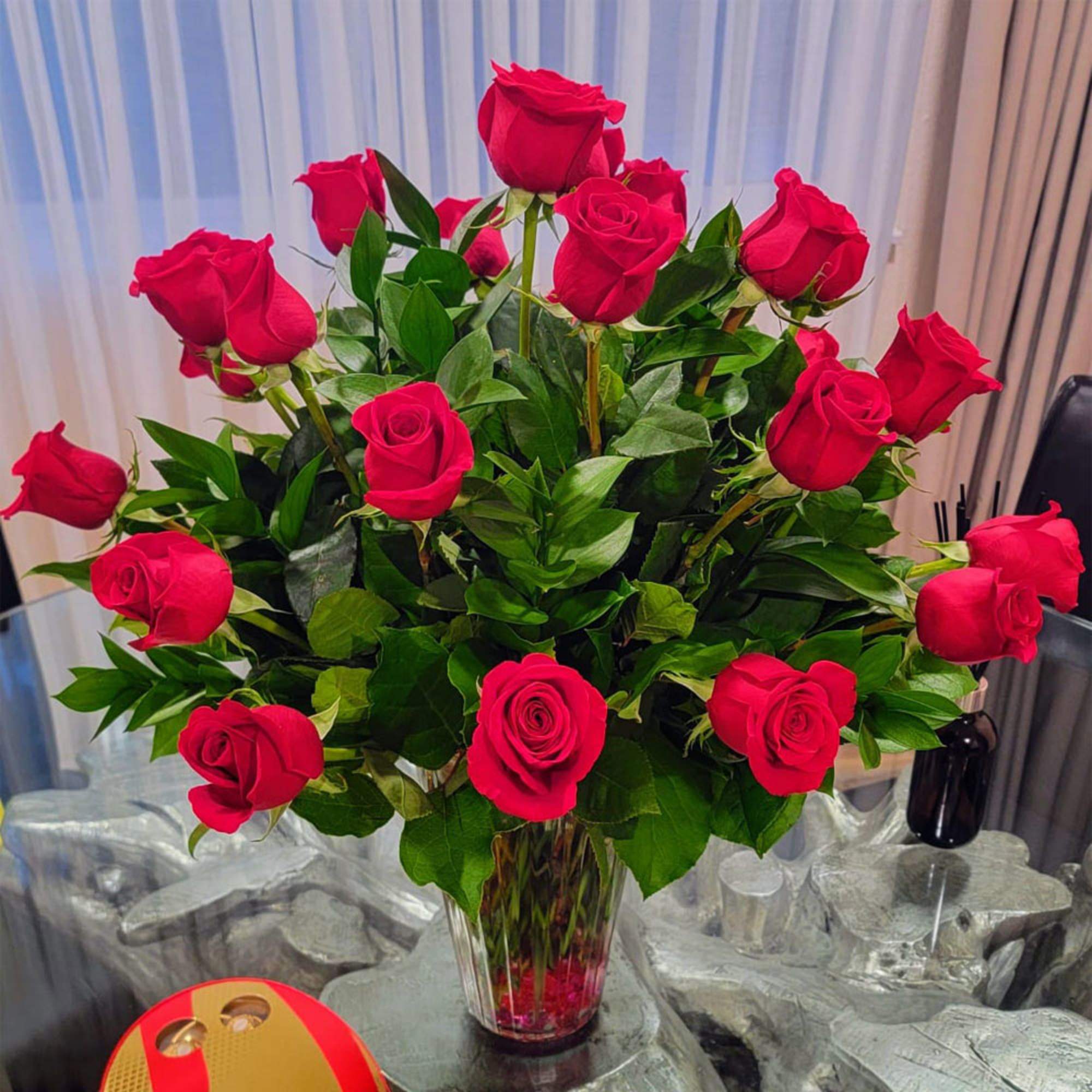 These passionate long stem red roses are professionally hand arranged in organic