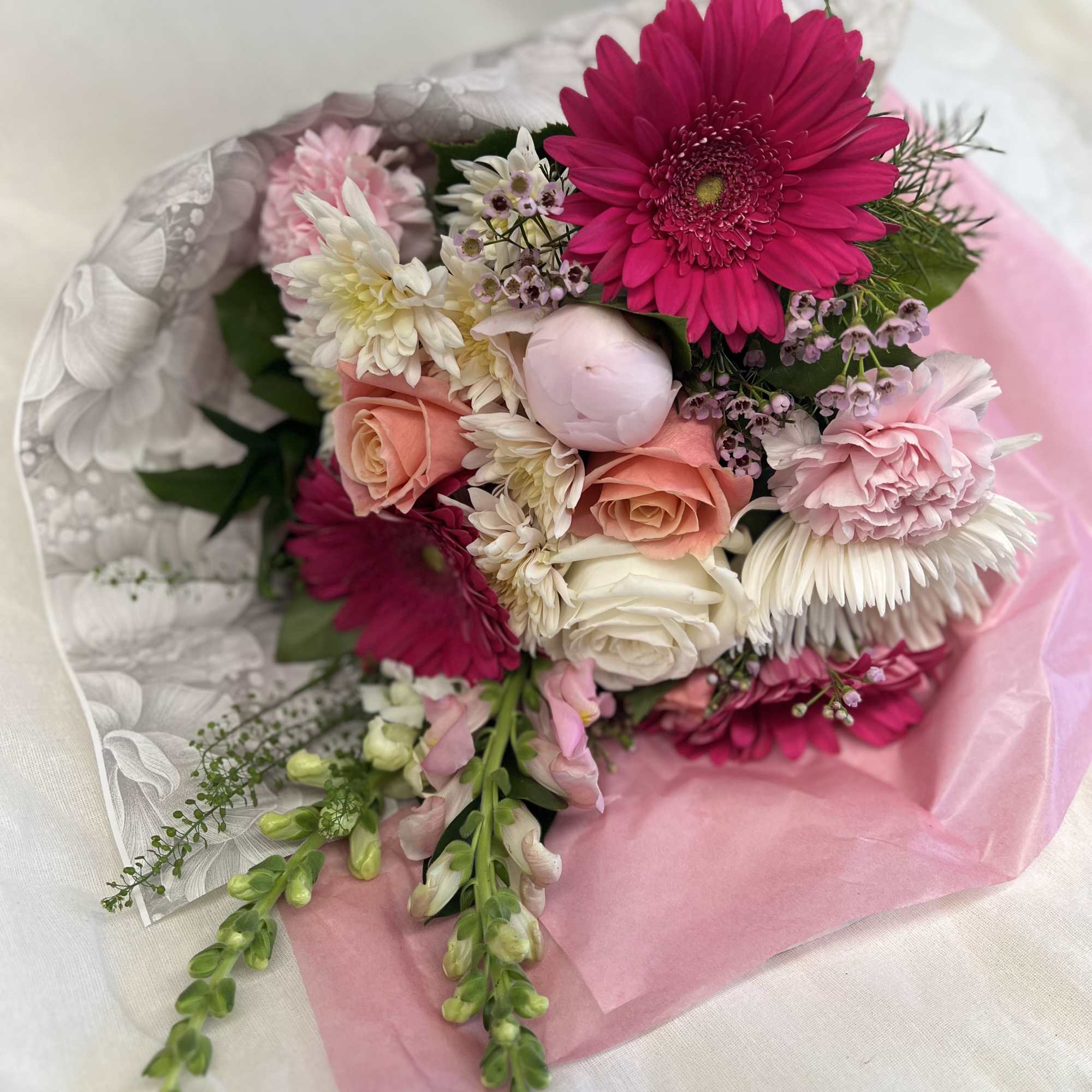 A handful or and armful of every shade of pink arranged in