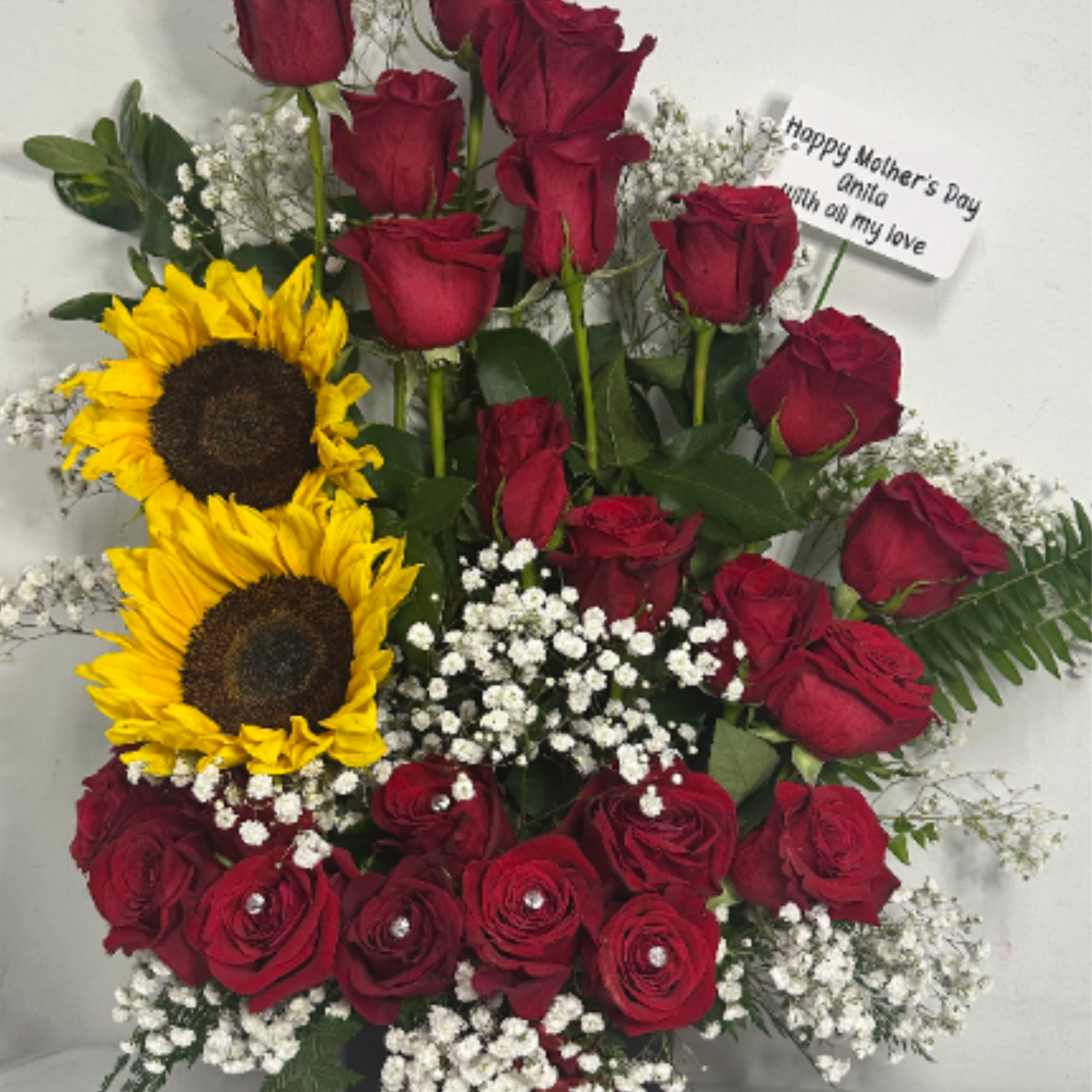 Floral arrangement with 24 roses and 2 sunflowers, perfect for any occasion