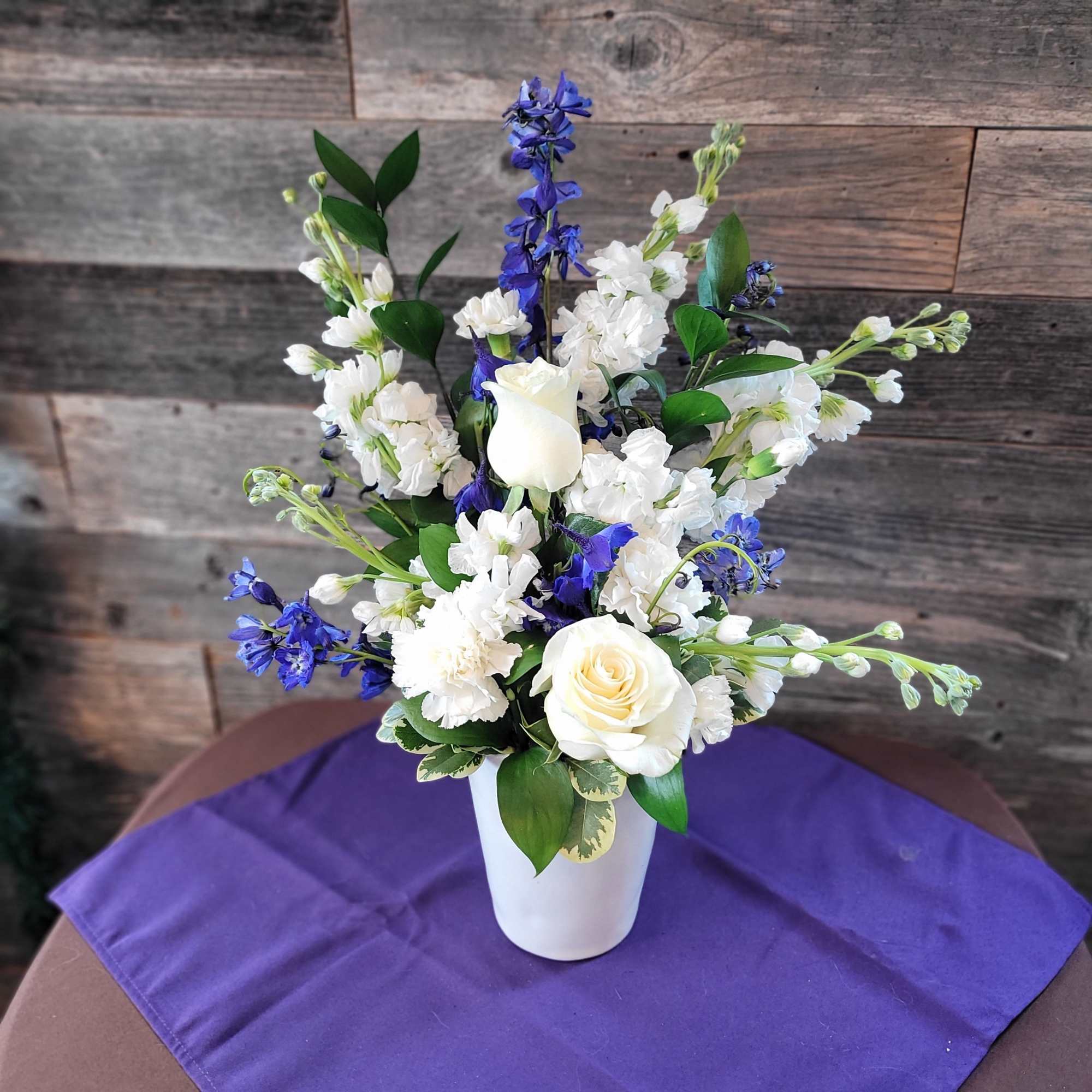 Blue and white arrangement  featuring fragrant Stock and blue delphinium. Perfect