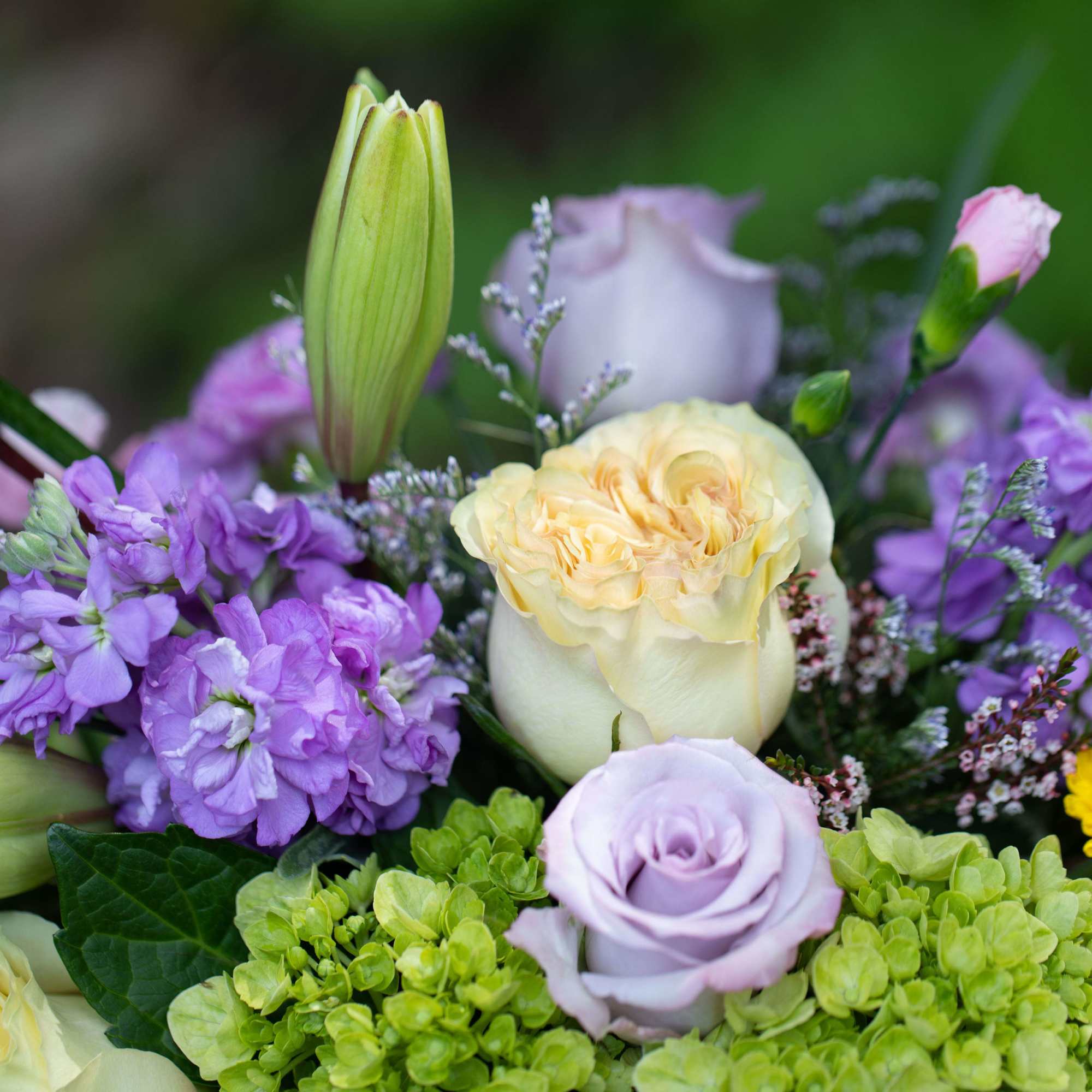 Elegantly designed garden style flowers arranged in a shabby chic novelty birch