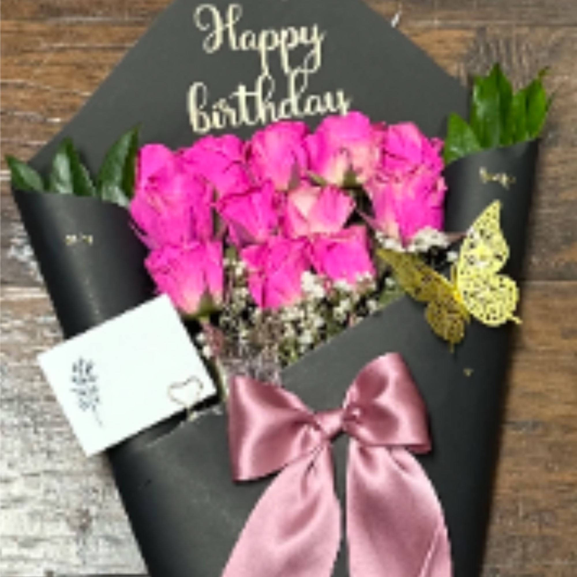 Elegant bouquet of 12 roses wrapped in black