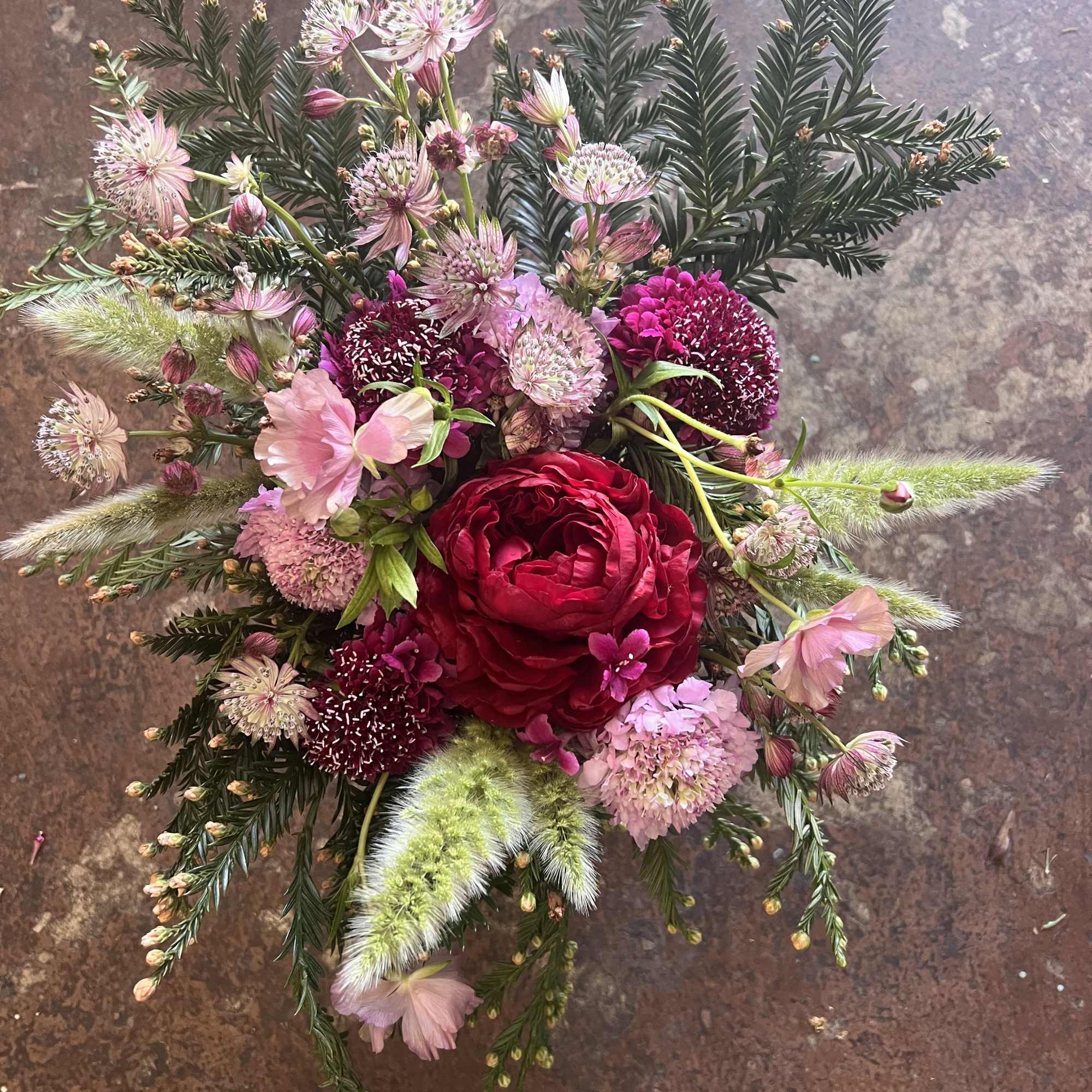 

A darling mix of blush pinks, a bold red bloom, and playful