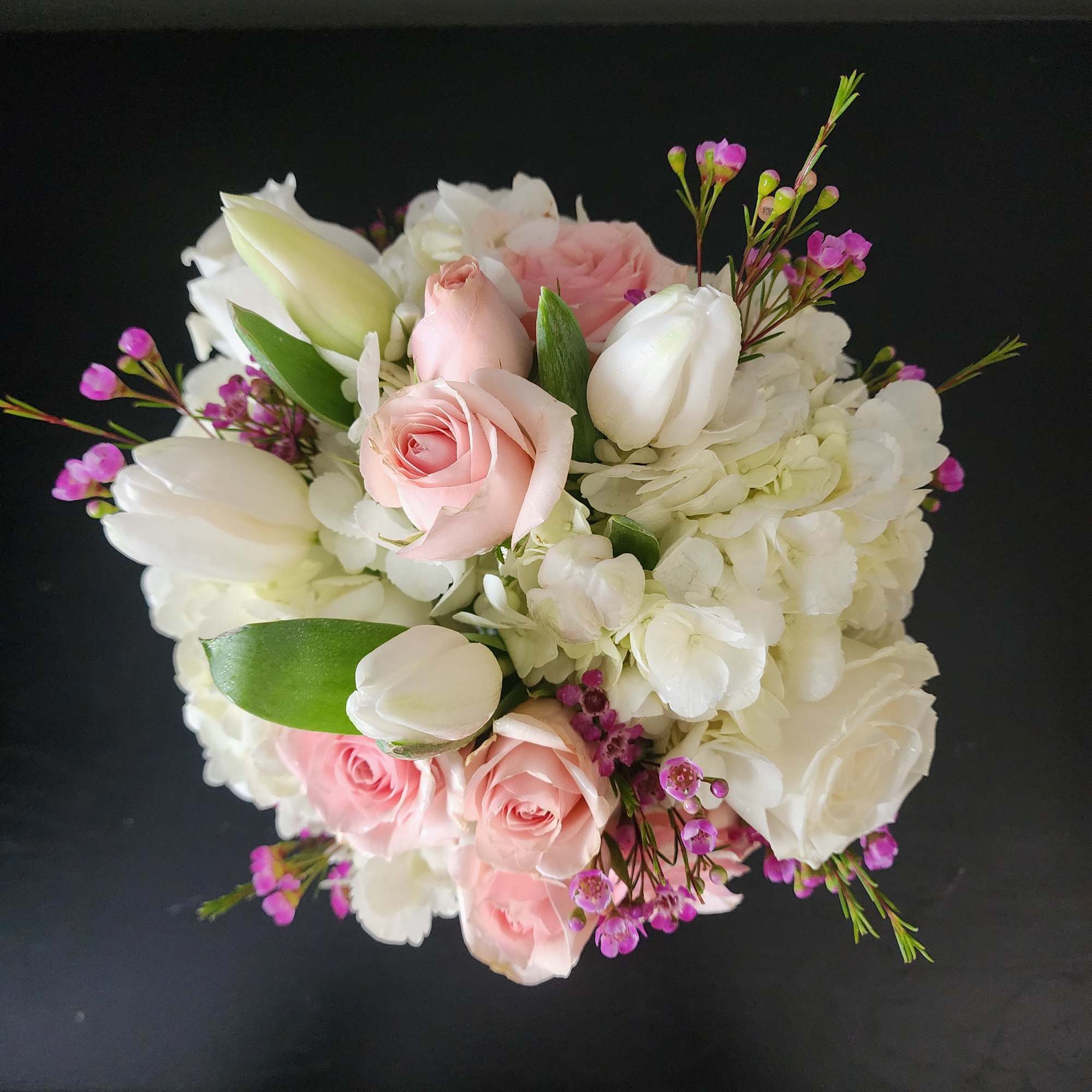 Beautifully designed in a glass cube with white hydrangea, white roses, white