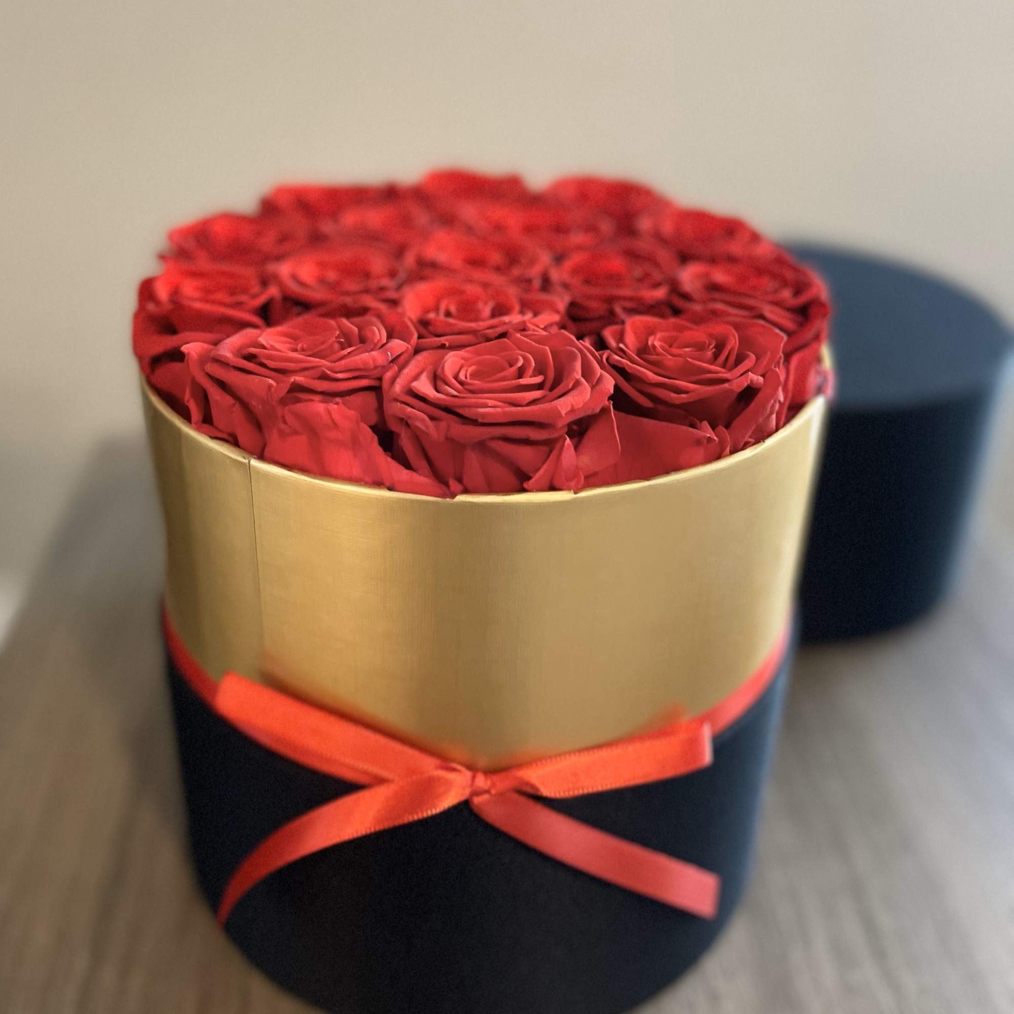 Stunning cylinder shaped box with 16 preserved  real red roses that