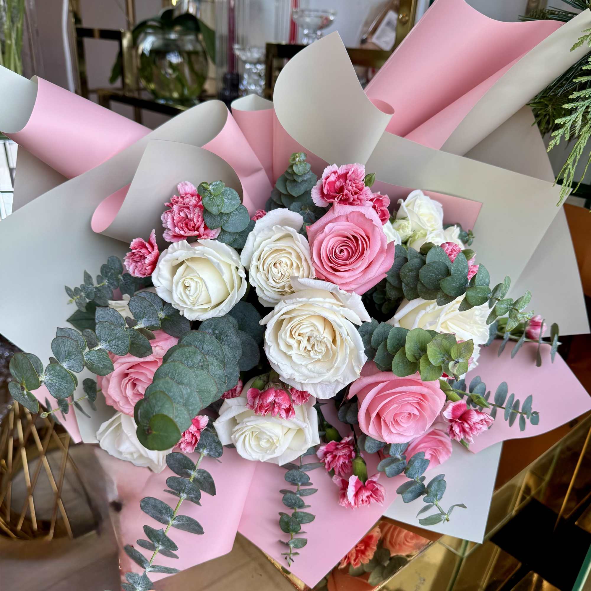 This romantic bouquet features premium pink and white roses paired with ruffled