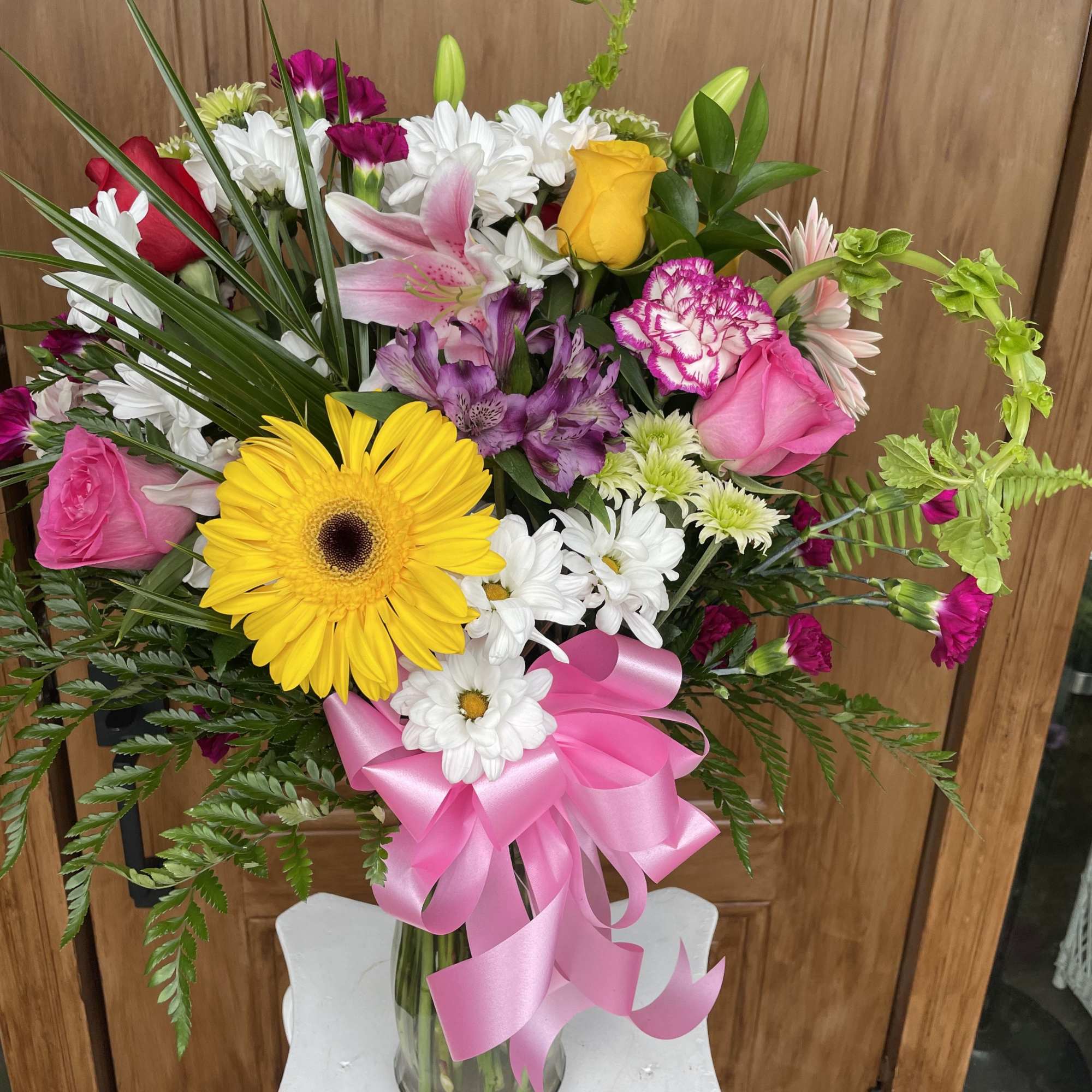 A beautiful vase arrangement, featuring pink lilies, white and pink and yellow