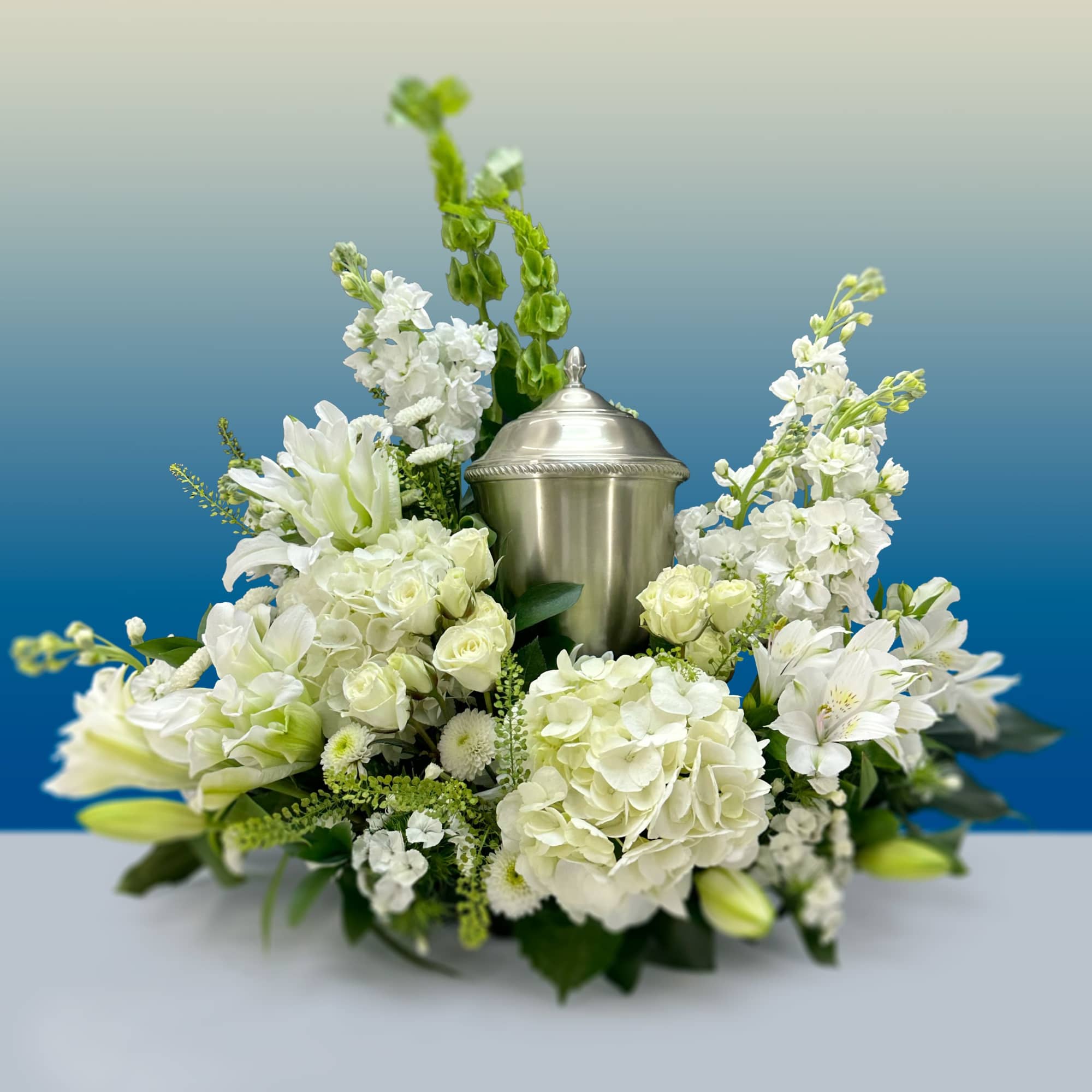 Your urn arrangement will be embraced by a calming palette of white