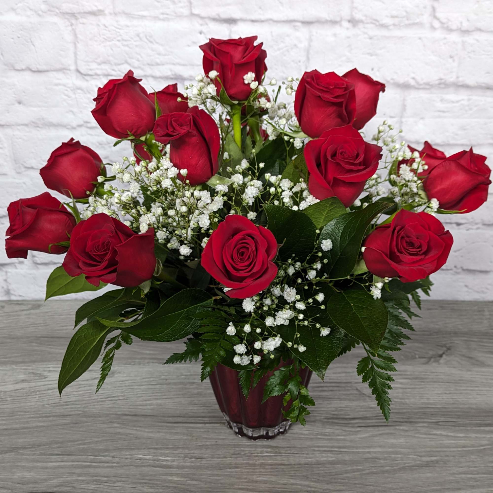 Refined Red Roses uses shorter rose stems in a colored glass vase