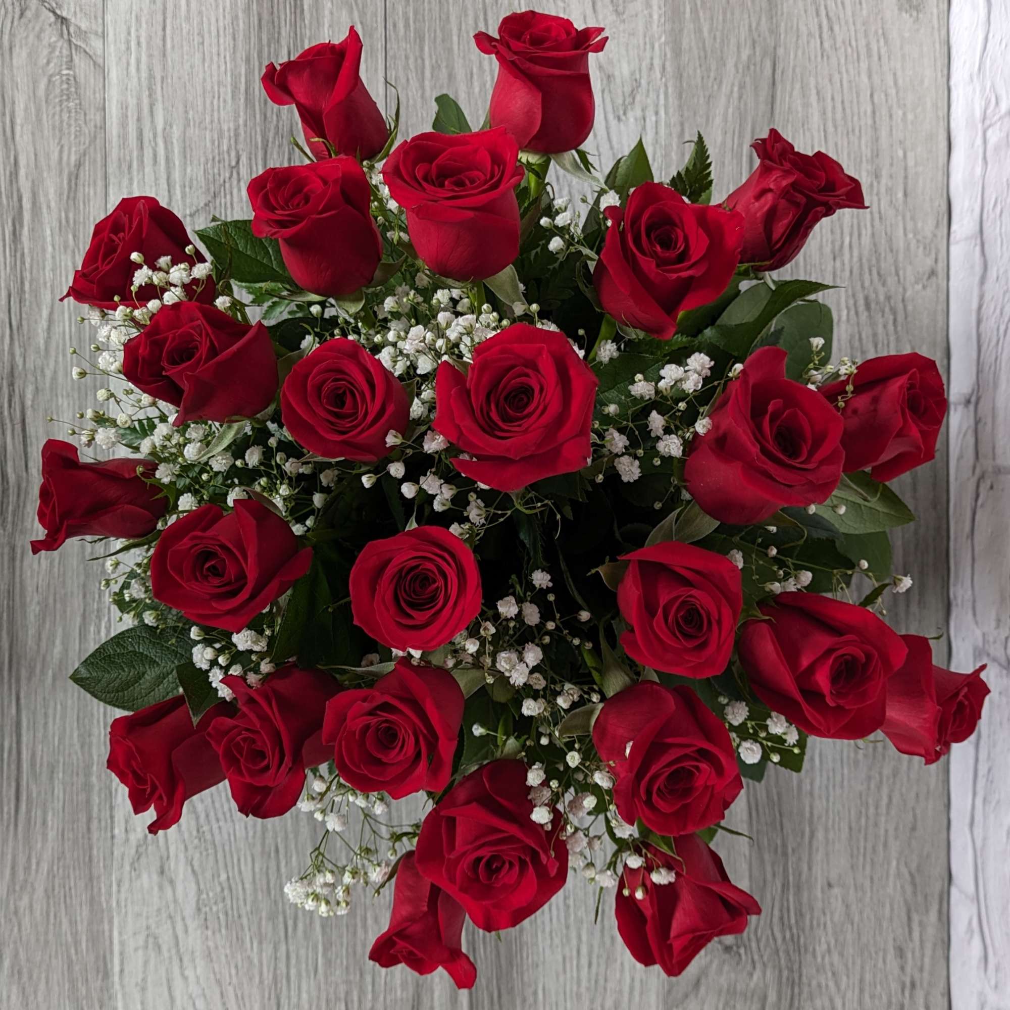 Refined Red Roses uses shorter rose stems in a colored glass vase