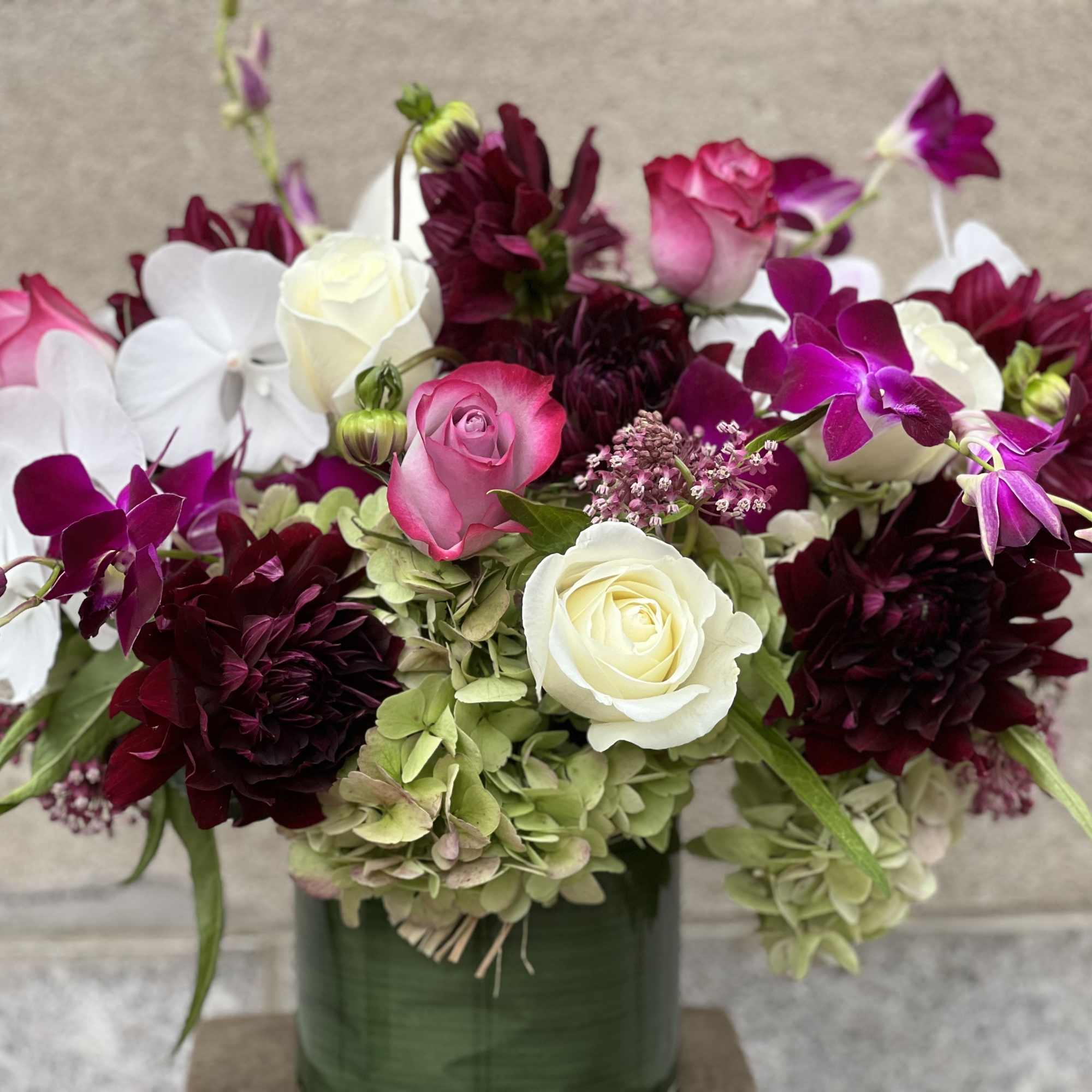 LUSH ASSORTMENT OF ROSES, PINK ASCLEPIAS, NUIT D'ETE DAHLIAS, WHITE PHALAENOPSIS ORCHIDS