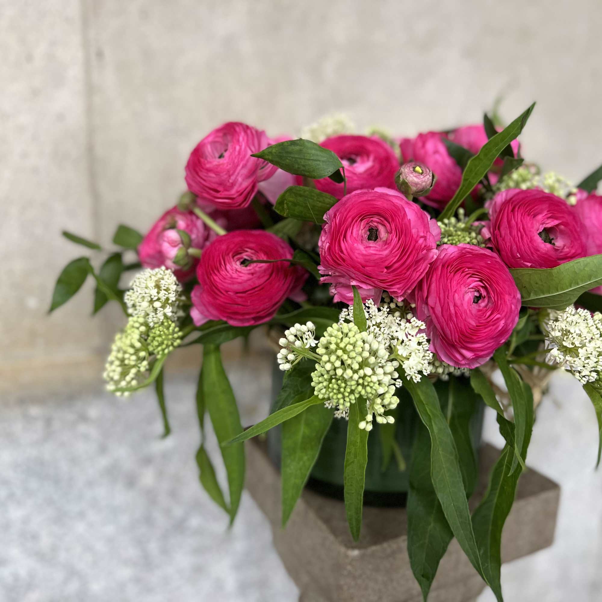 This elegant arrangement, complemented by swirling premium ranunculos , soft and subtle