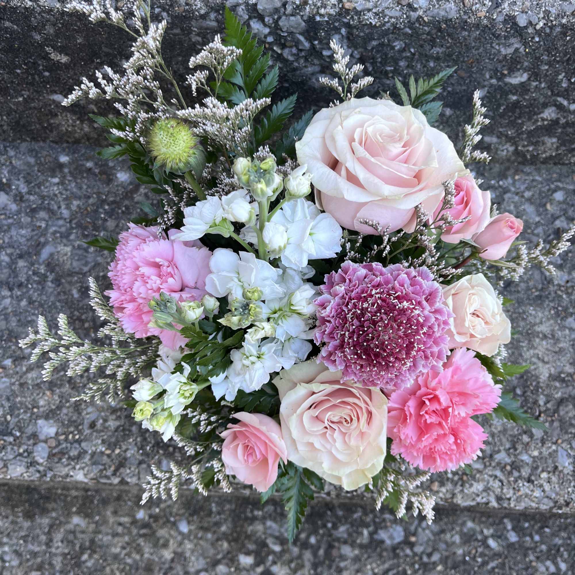This beautiful arrangement has stock, roses, spray, roses, Misty, Scabiosa. Carnations and